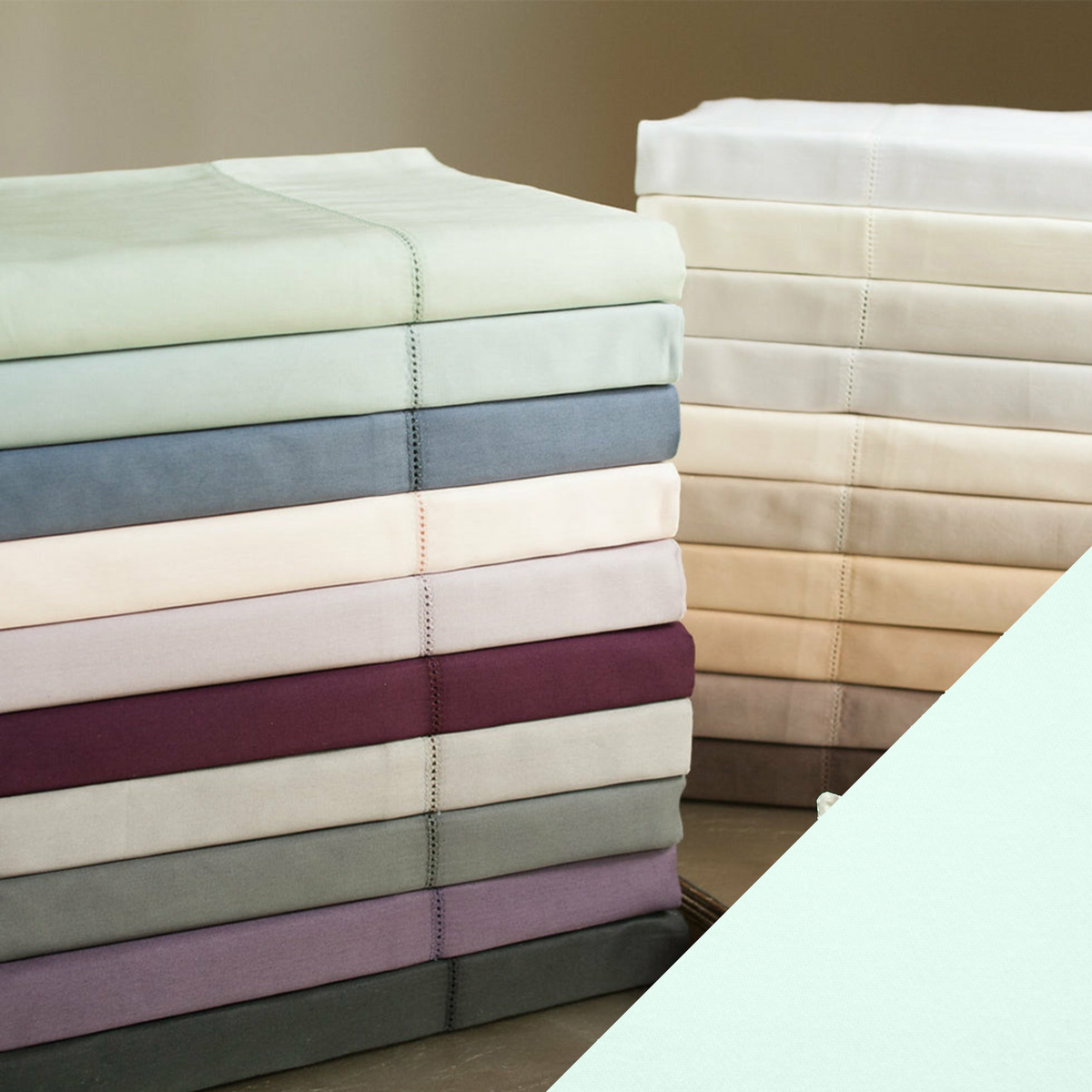 Stack of Home Treasures Royal Sateen Bedding with Ice Color Swatch