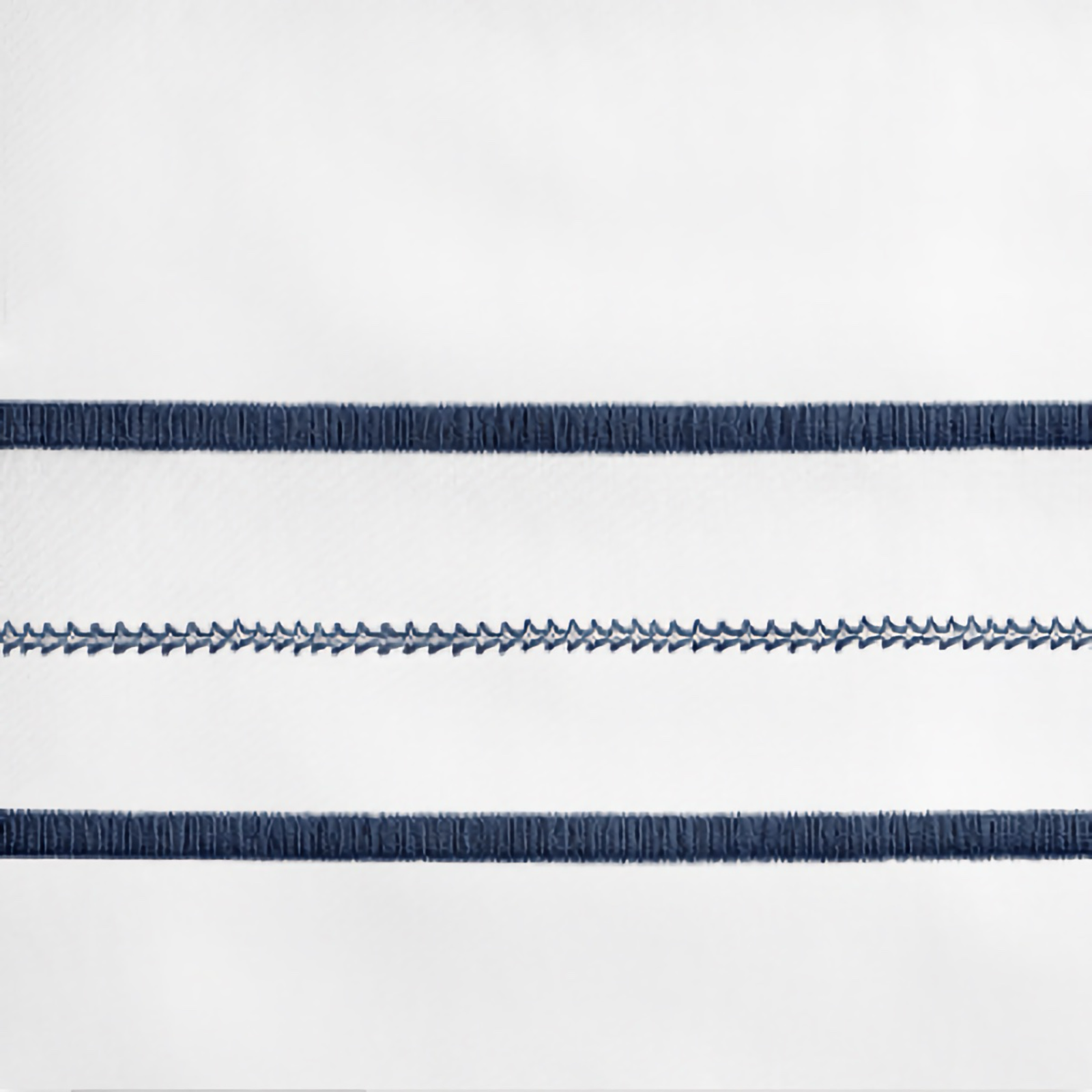 Lifestyle Image of Home Treasures Triad Bedding with White/Navy Blue Swatch