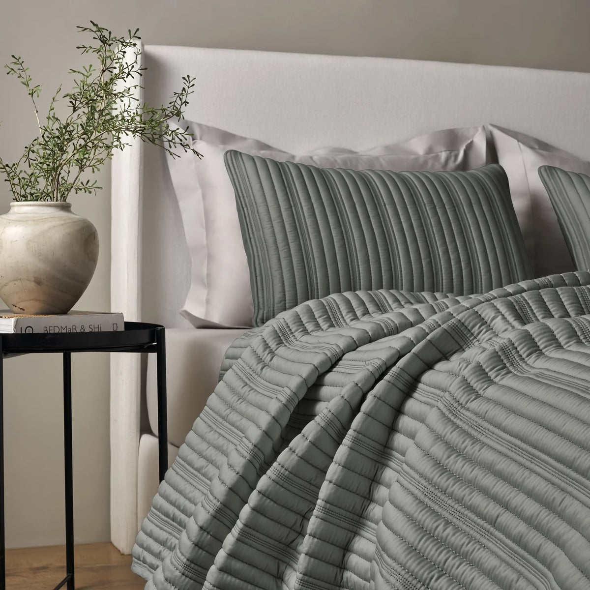 Side view of a bed with Slate colored Ann Gish Rib Coverlet Set