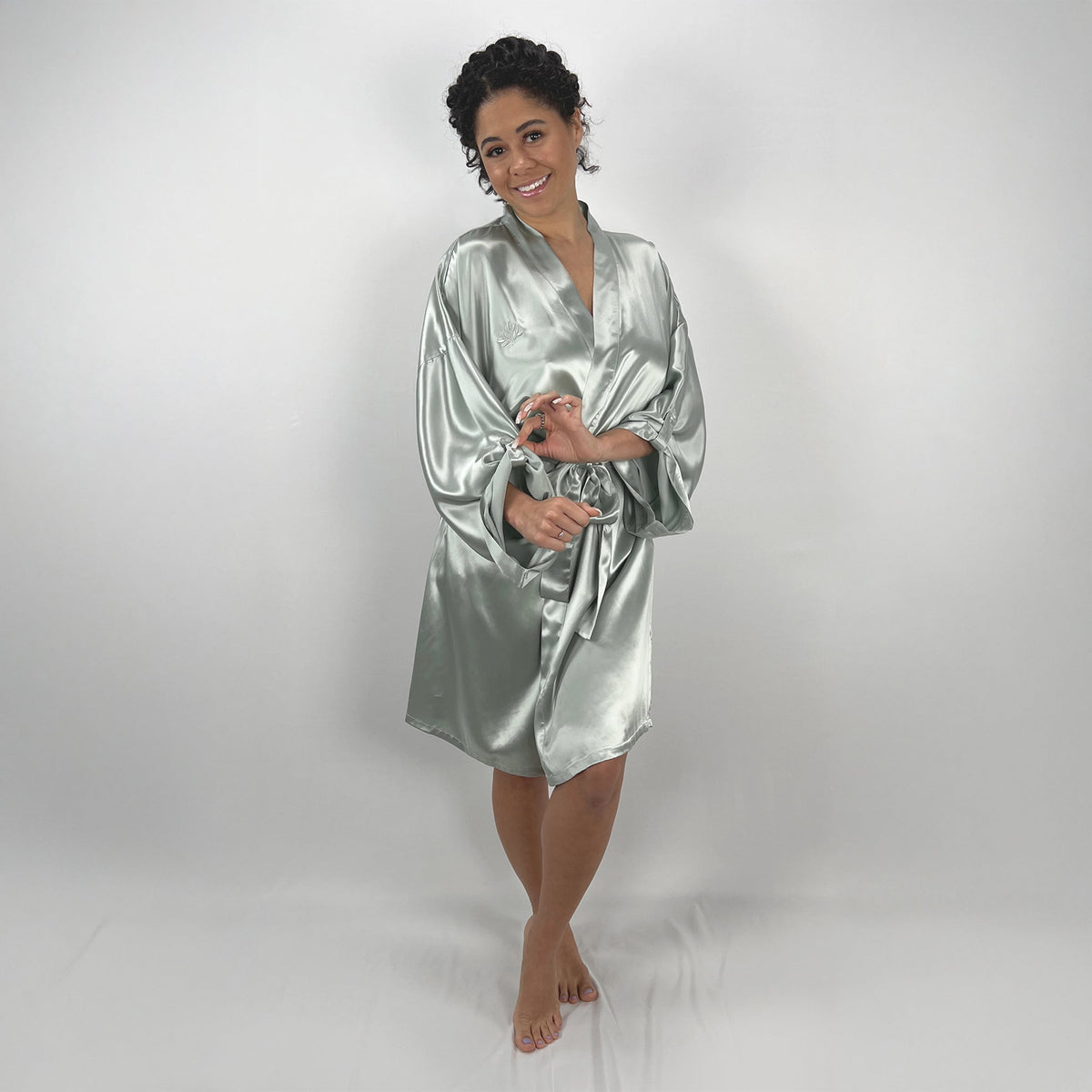 Model wearing a pure silk kimono robe, showcasing its soft texture from various angles in a GIF