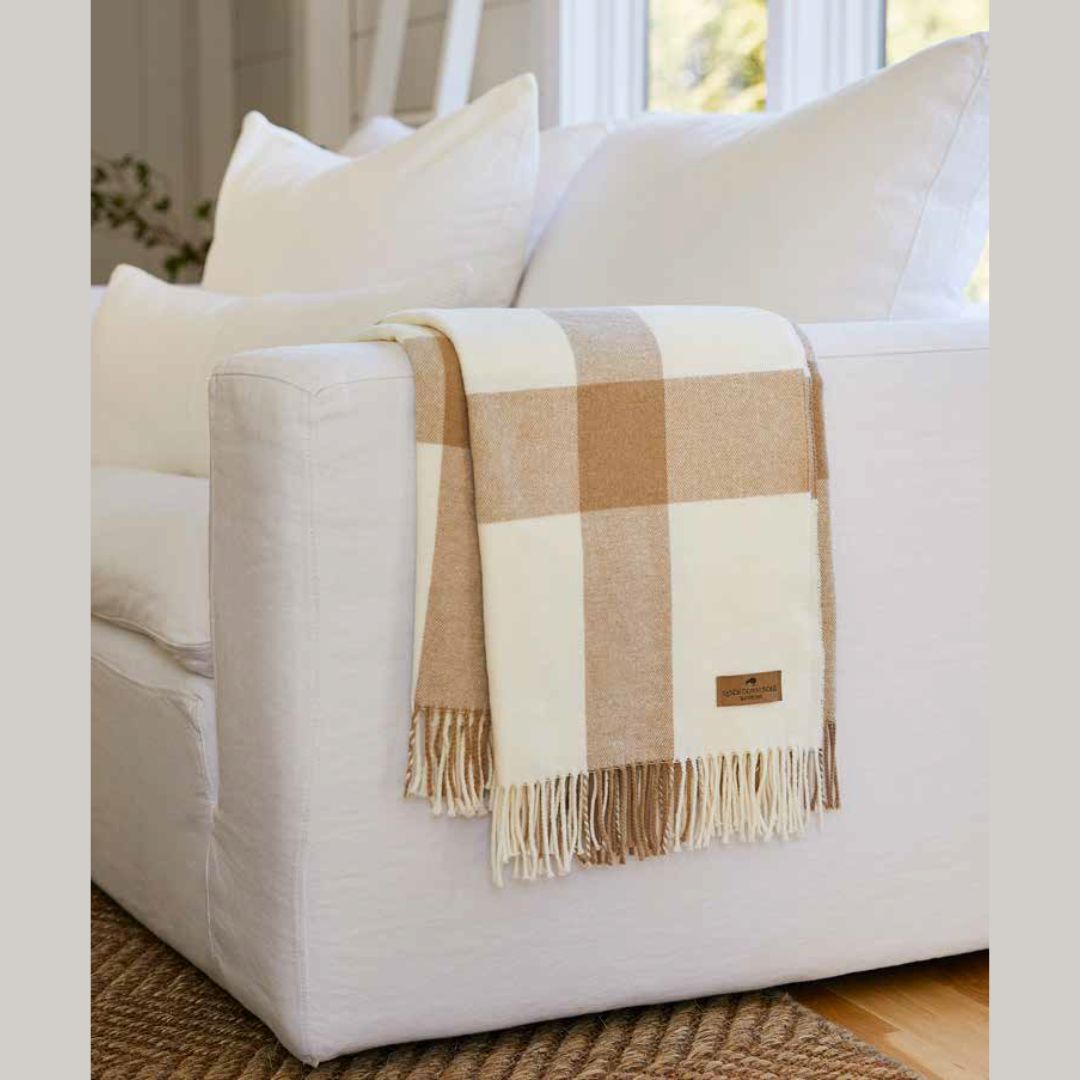 Lands Downunder Wellington Plaid Throw draped over a white couch
