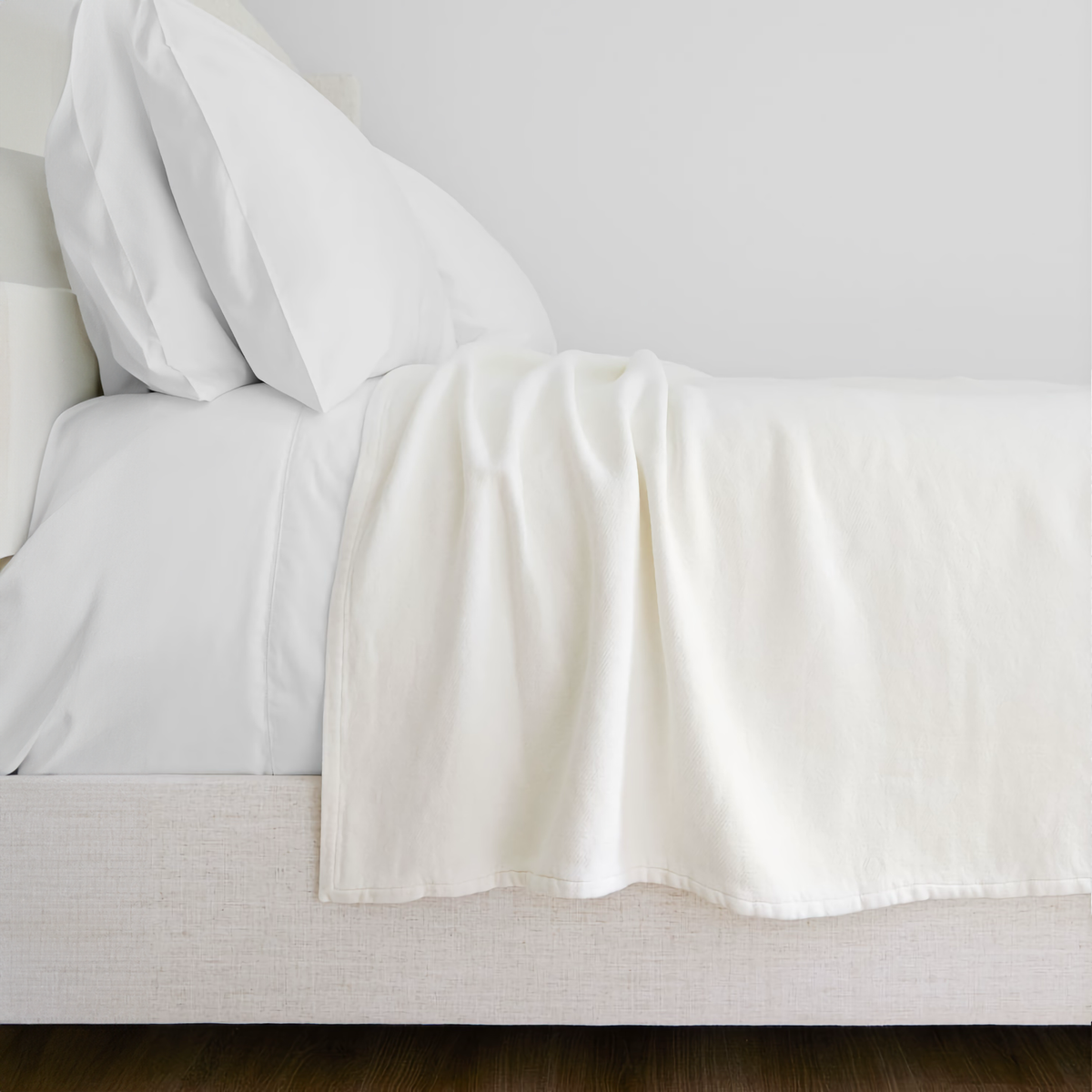 Lands Downunder Bristol Cotton Blanket in Off-White Color on a Bed