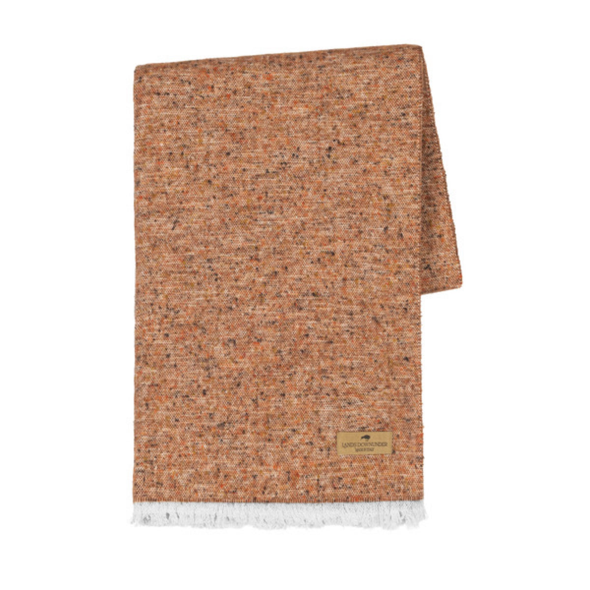 A folded Lands Downunder Cinder Mist Throw in Rust color with a speckled pattern and white fringed ends