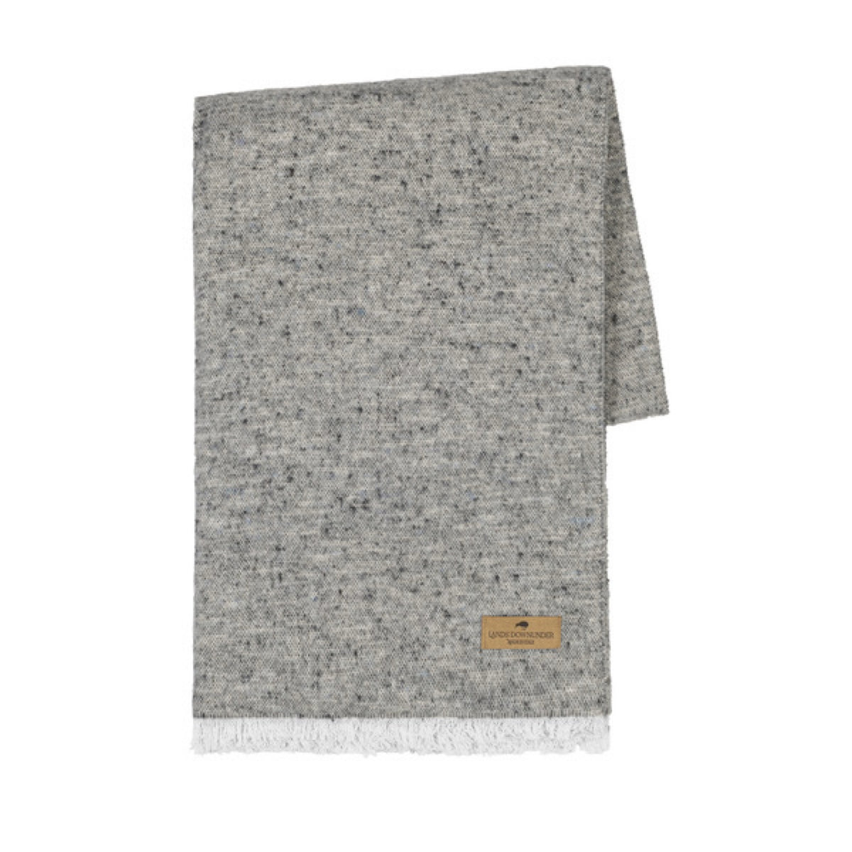 A folded Lands Downunder Cinder Mist Throw in Stone color with a speckled pattern and white fringed ends