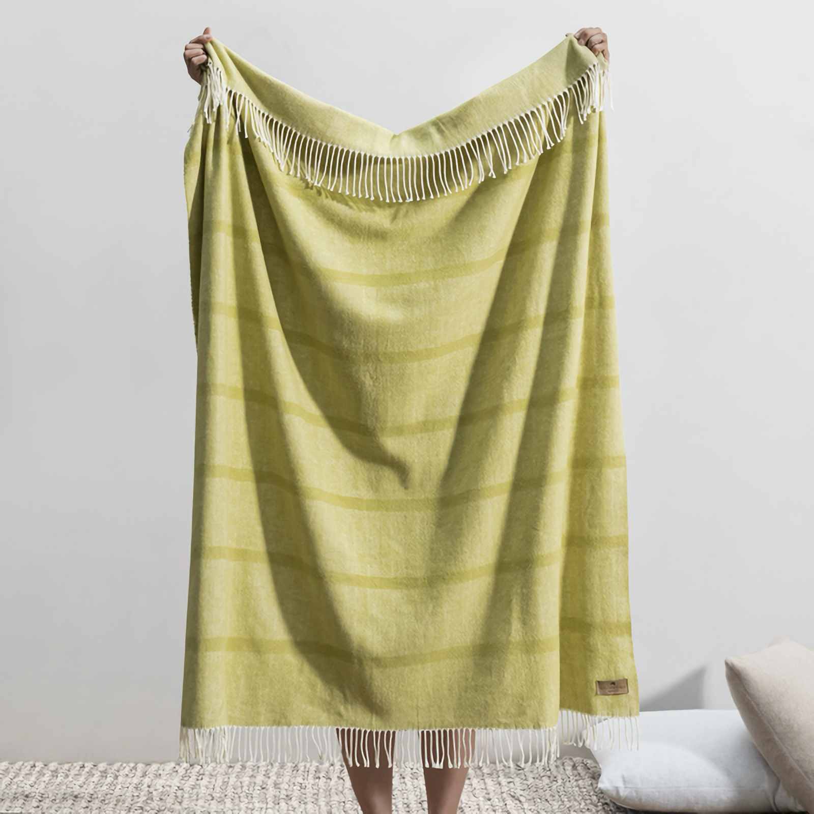 Lifestyle Shot of Lands Downunder Montauk Stripe Herringbone Throws in Lemongrass Color