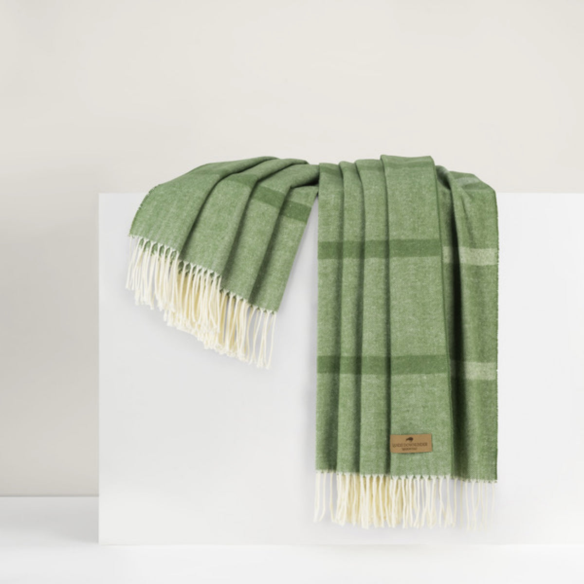 Lands Downunder Montauk Stripe Herringbone Throws in Meadow color draped on a white surface