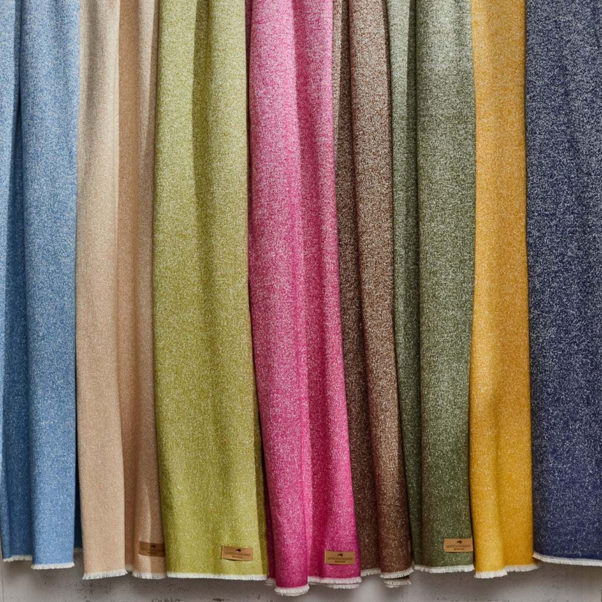 Lands Downunder Sedona Throws in various colors hang in a row