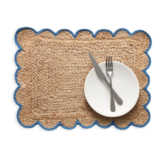 Woven placemat with scalloped edge on a white background