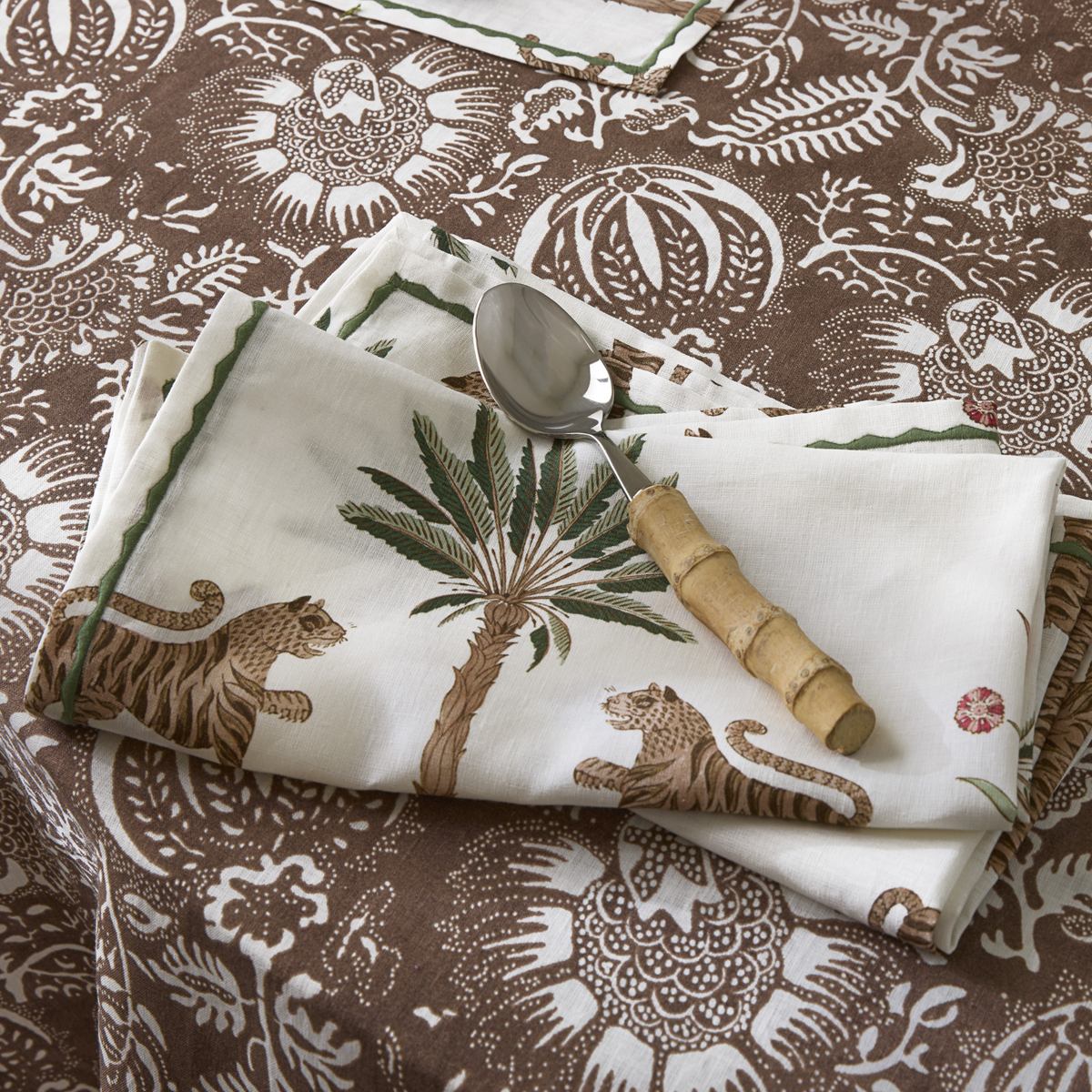 Lifestyle Image of Matouk Tiger Palm Table Linens with Granada Tigereye 