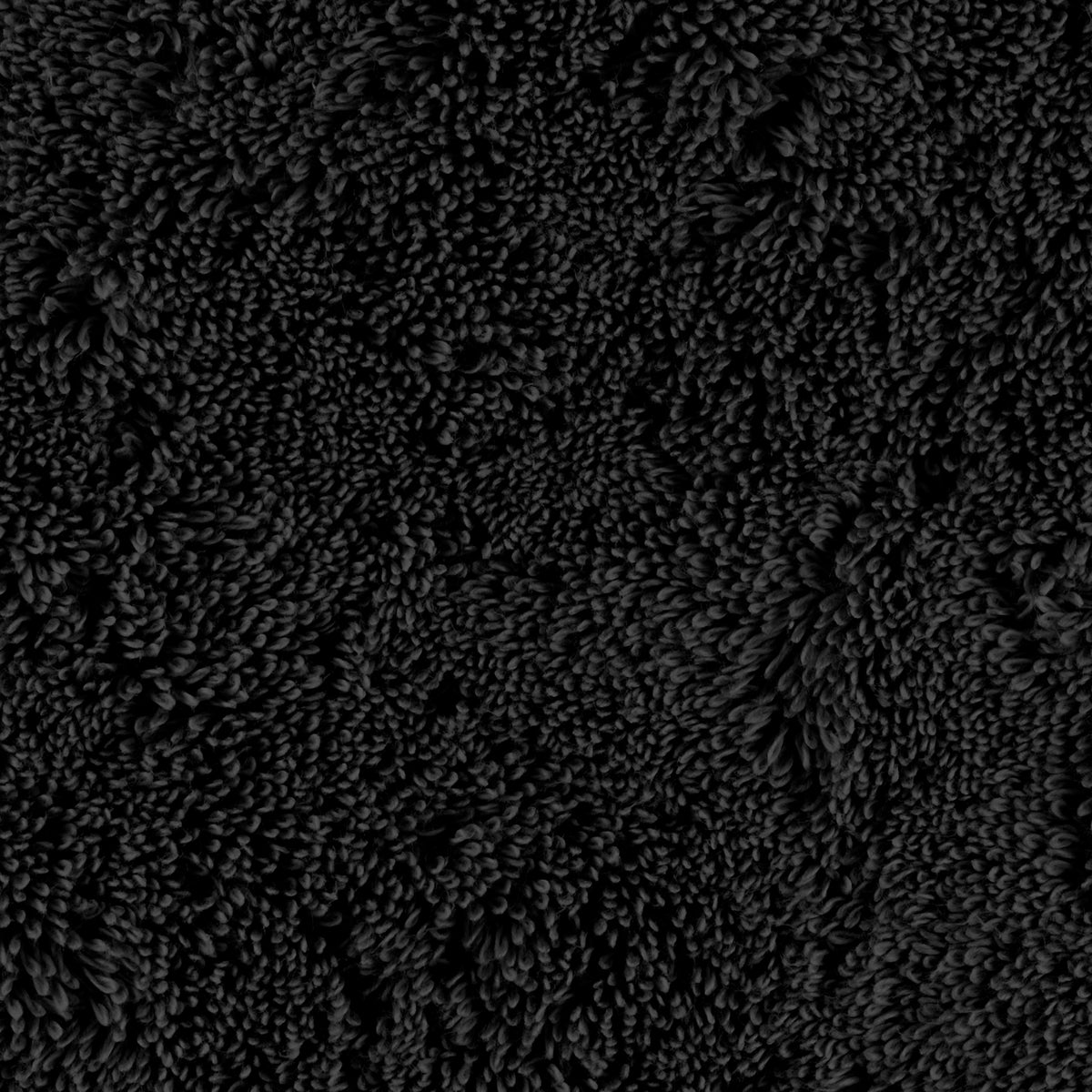 Dense black textured surface resembling plush cotton towels with clustered, raised, leaf-like patterns throughout.