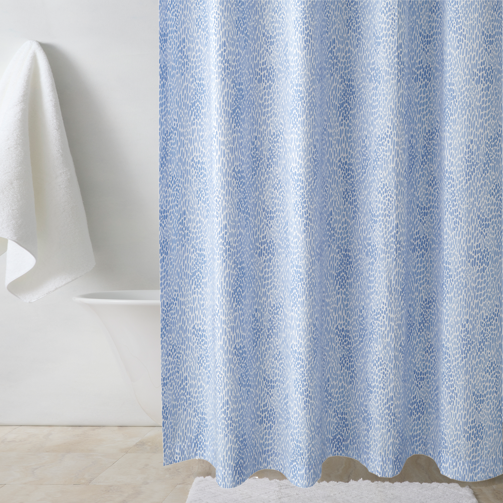 Bath Tub Behind a Lulu DK Matouk Nikita Shower Curtain in Azure Color