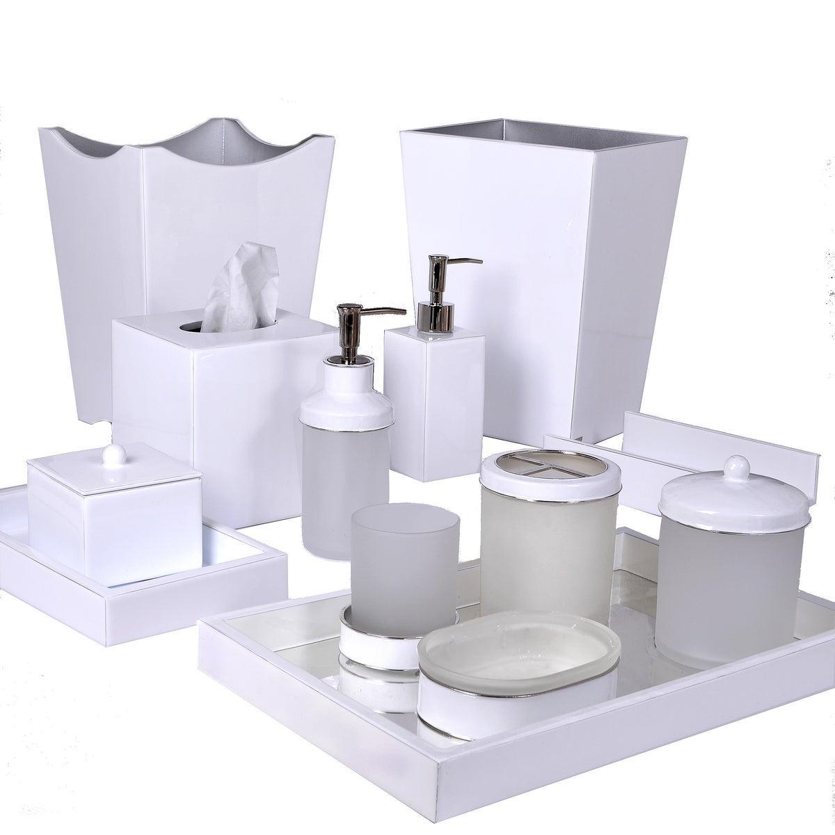 A white enamel vanity collection of custom handmade bath accessories—trays, dispensers, a tissue box, and waste bins.