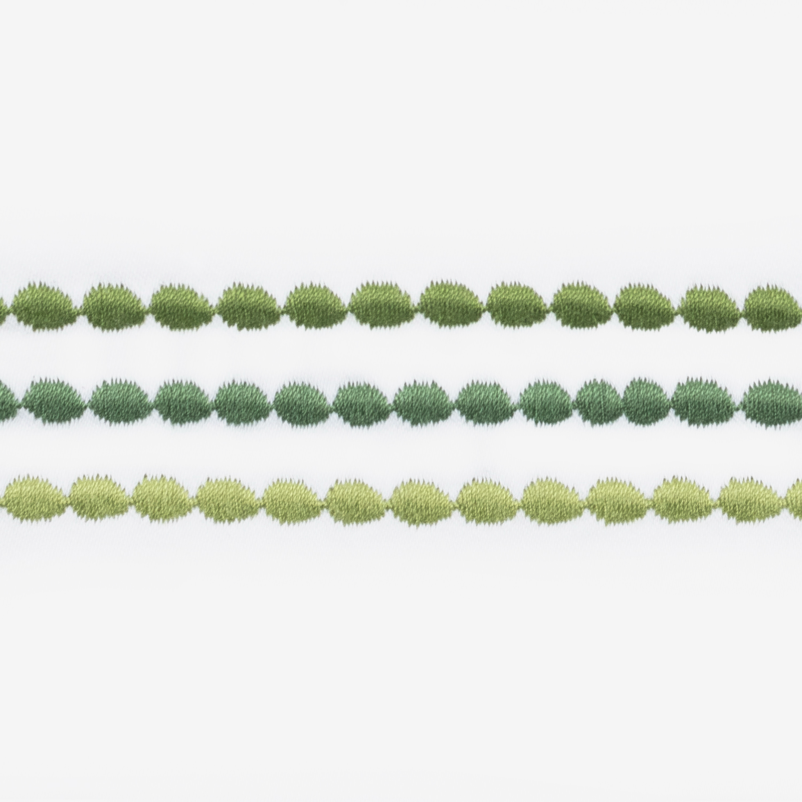 Side view of Bed in Matouk Amara Triple Pearl Bedding Collection with Palm Green Swatch