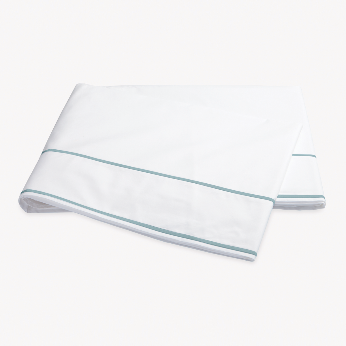 Folded Flat Sheet of Matouk Ansonia Bedding in Pool color