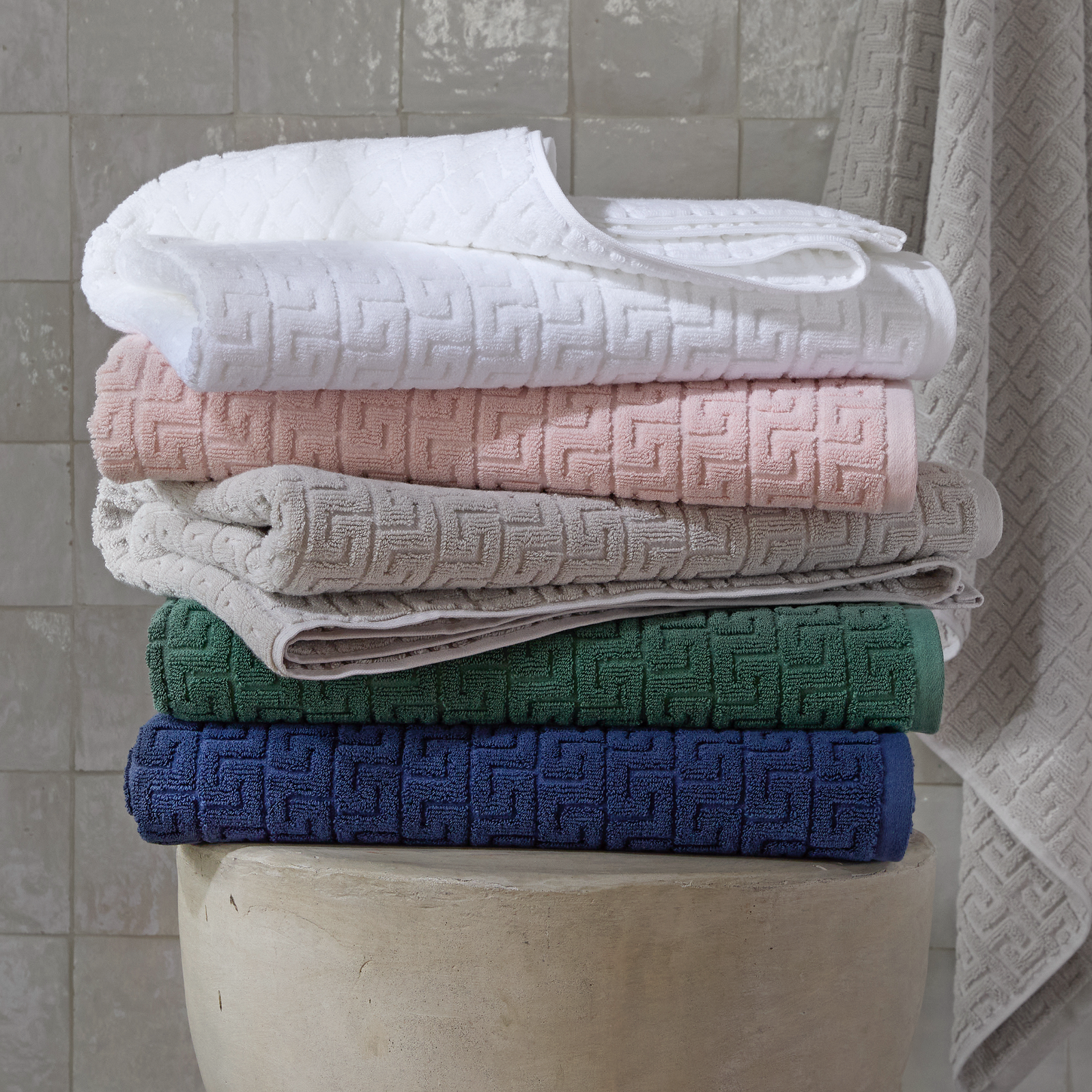 Stack of Matouk Schumacher Athena Bath Towels in Different Colors