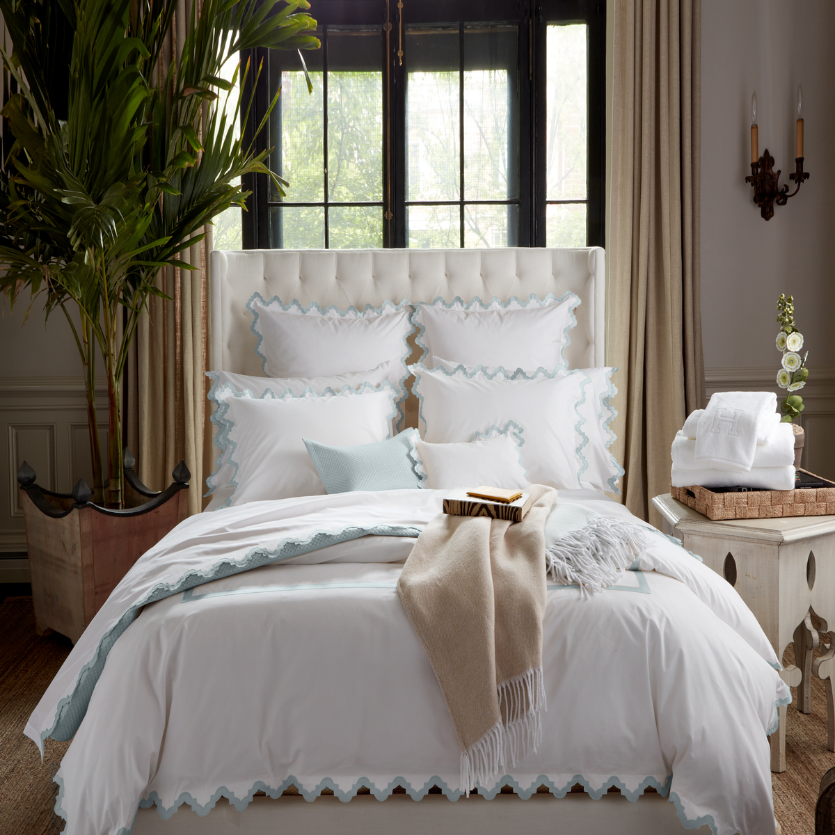 Lifestyle Image of a Full Bed Dressed in Matouk Aziza Bedding in Pool Color