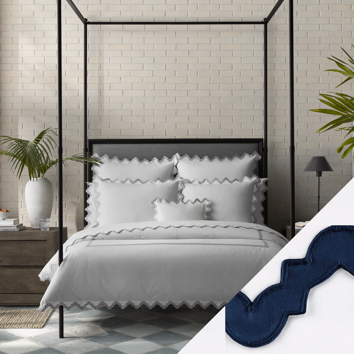Lifestyle Image of a Full Bed Dressed in Matouk Aziza Bedding in Silver Color with Navy Swatch