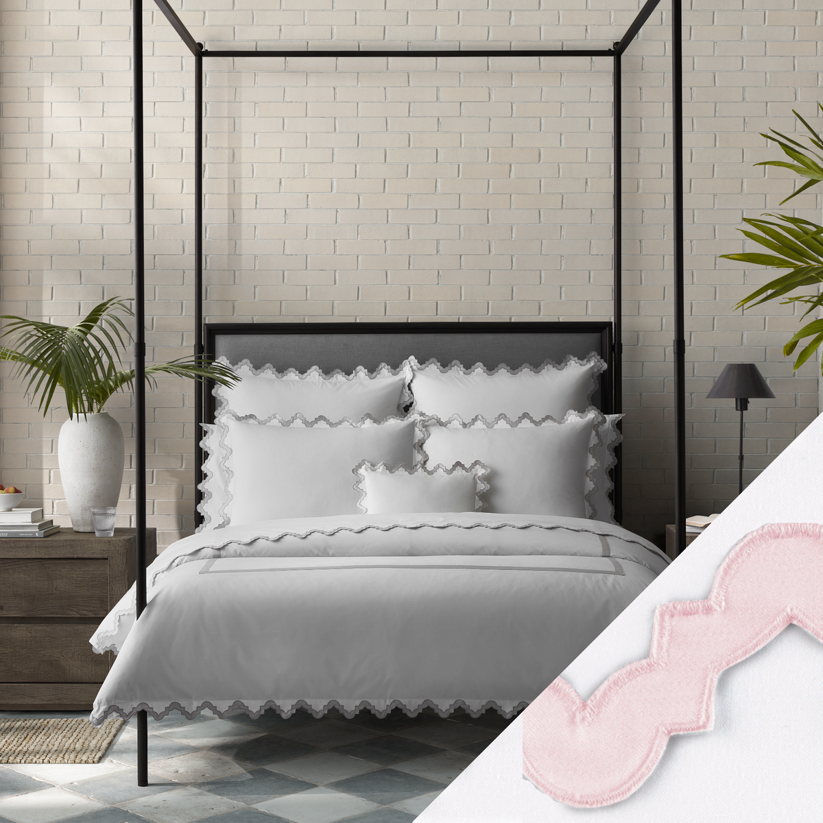 Lifestyle Image of a Full Bed Dressed in Matouk Aziza Bedding in Silver Color with Pink Swatch