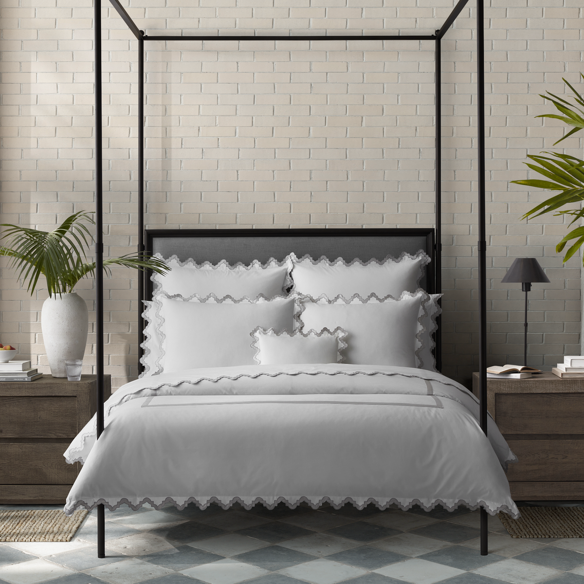 Lifestyle Image of a Full Bed Dressed in Matouk Aziza Bedding in Silver Color