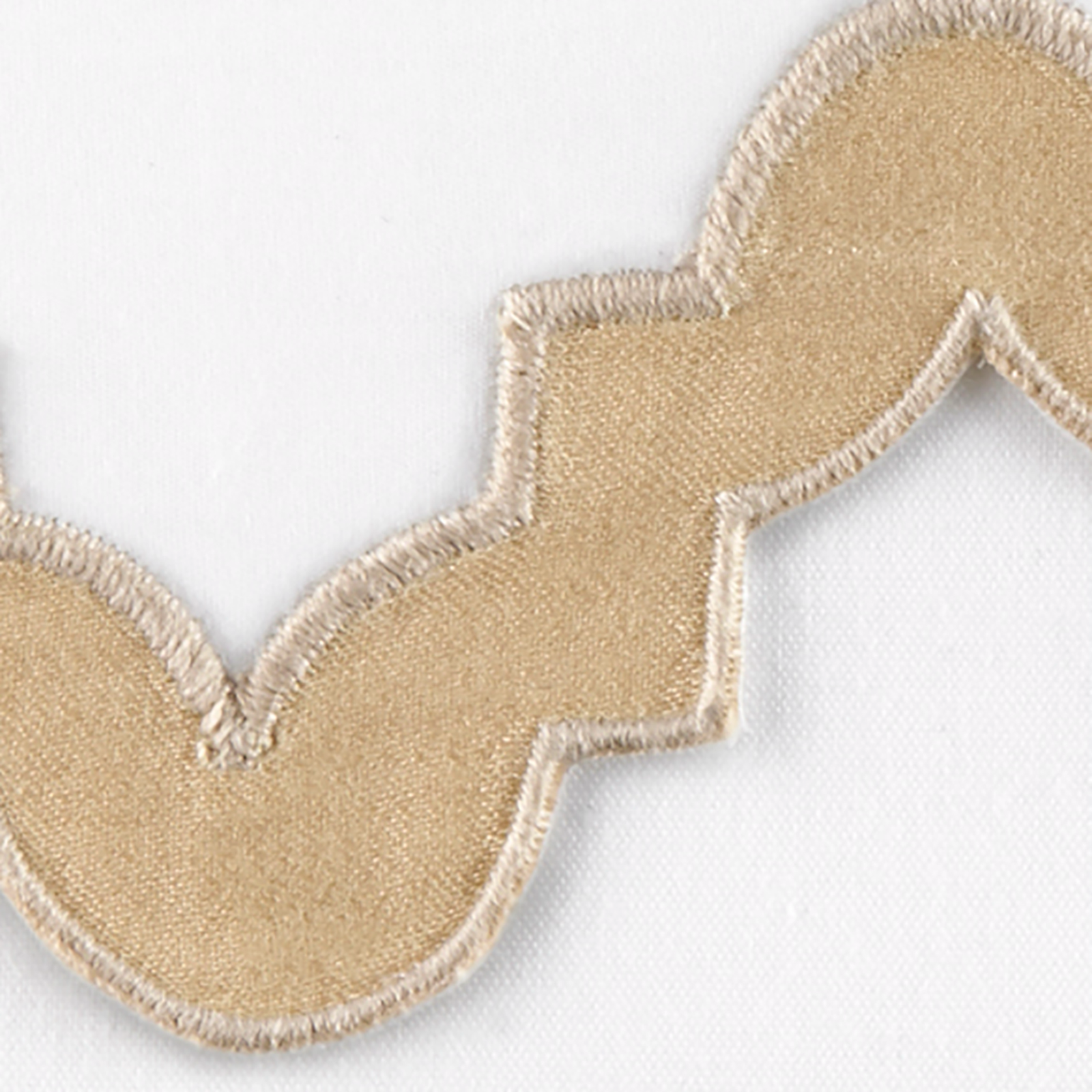 Lifestyle Image of a Full Bed Dressed in Matouk Aziza Bedding in Champagne Color