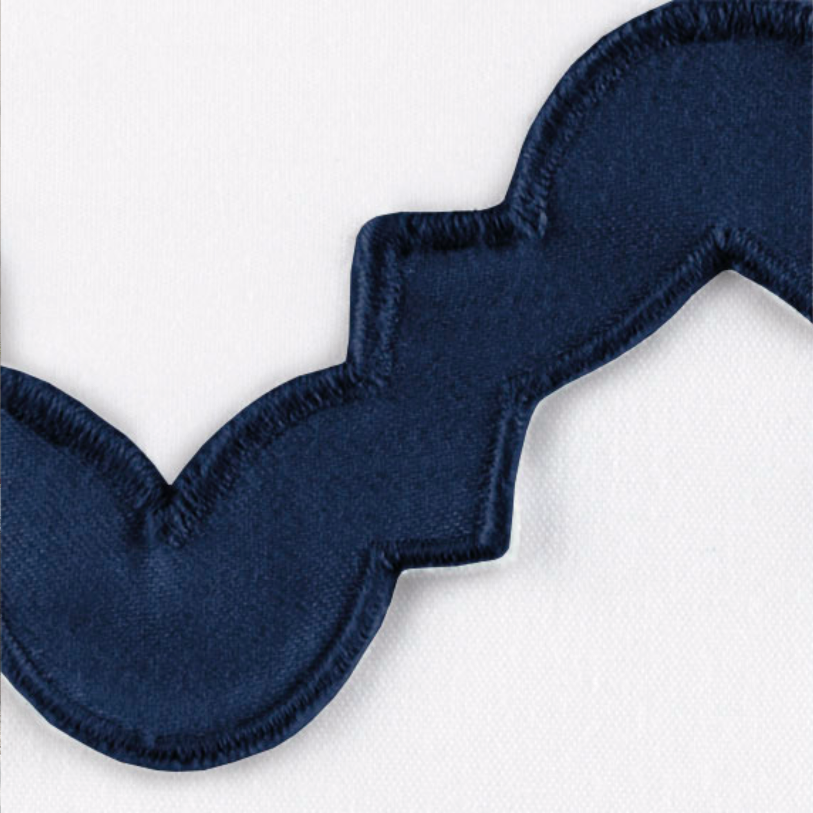 Lifestyle Image of a Full Bed Dressed in Matouk Aziza Bedding in Silver Color with Navy Swatch