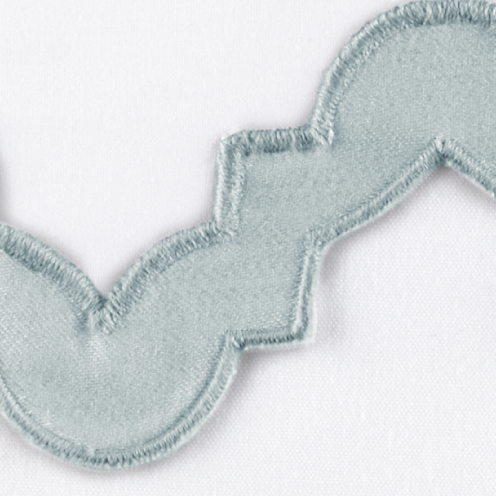 Lifestyle Image of a Full Bed Dressed in Matouk Aziza Bedding in Pool Color