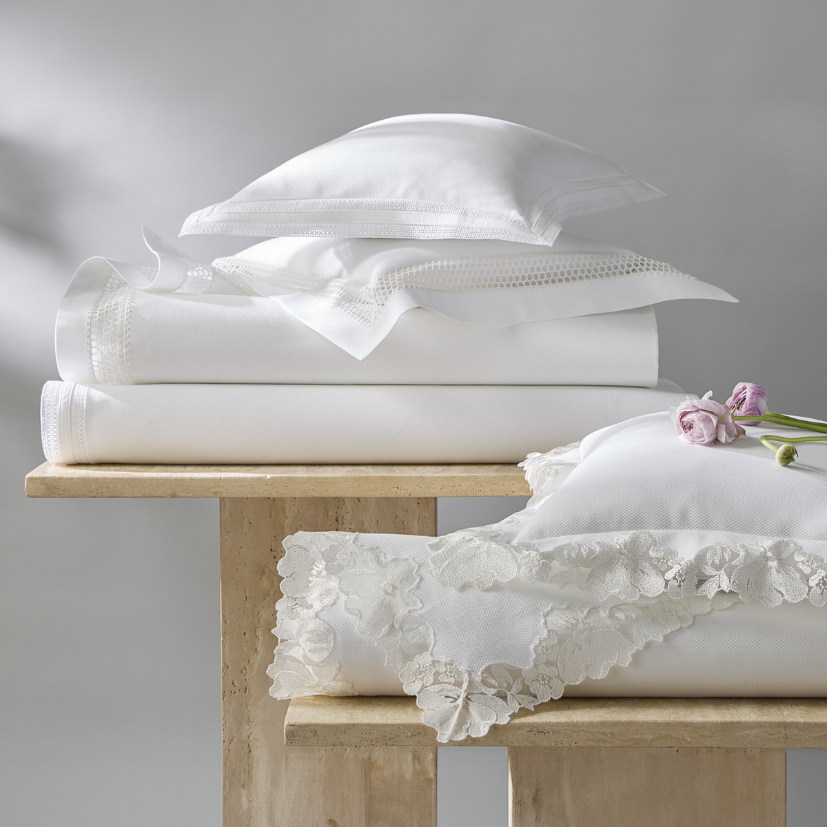 Stack of White Matouk Virginia, Grace and Cecily Lace Pique Bedding