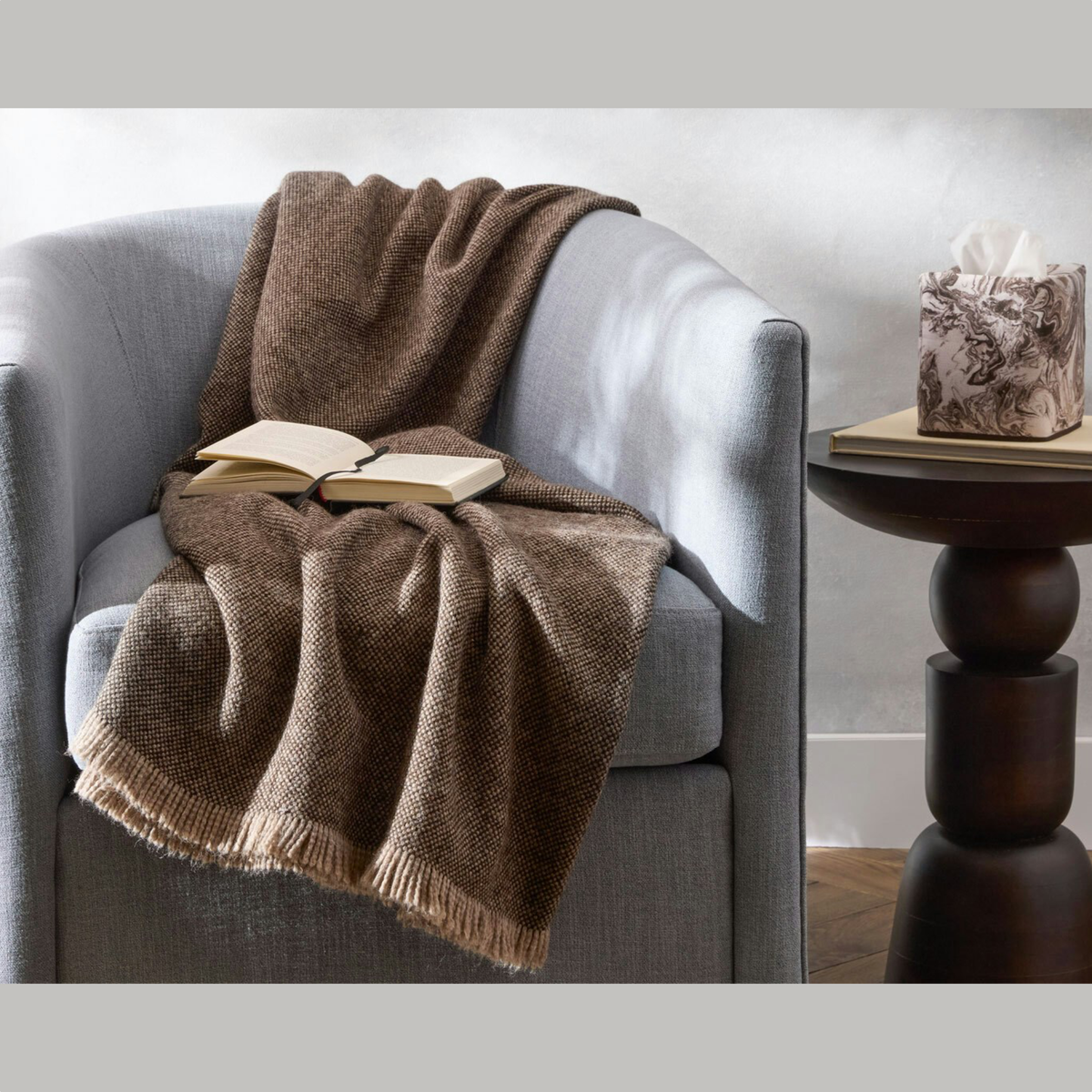 Topaz Matouk Bernardo Throw on a sofa