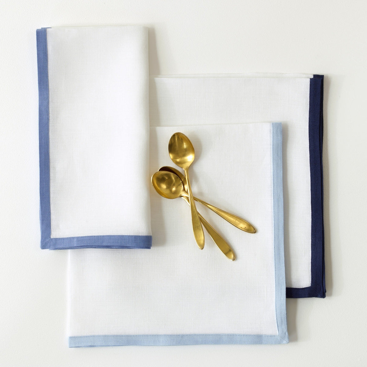 Matouk Border Napkins with Gold Spoons in Different Colors