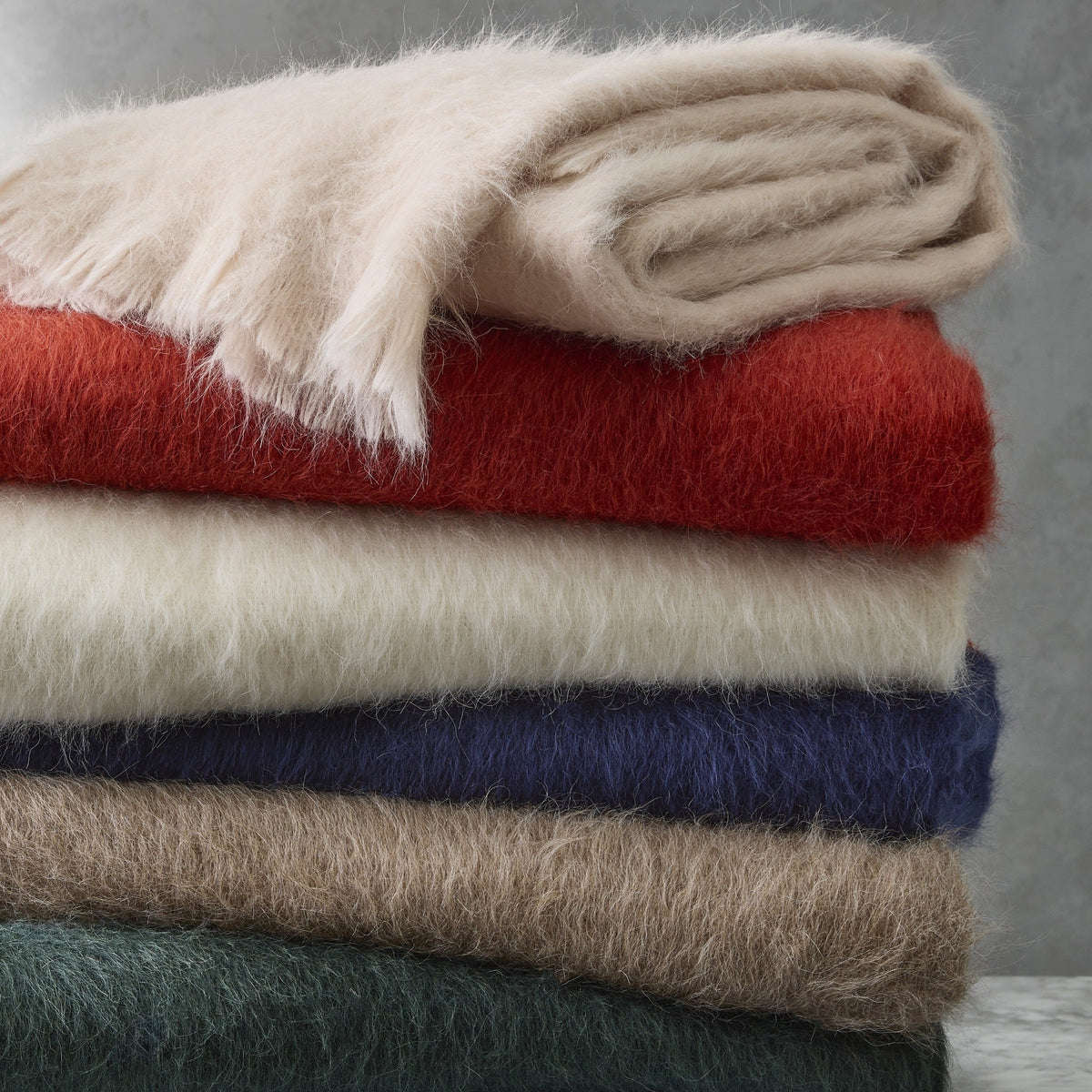 Stack of Matouk Bruno Throws in Different Colors