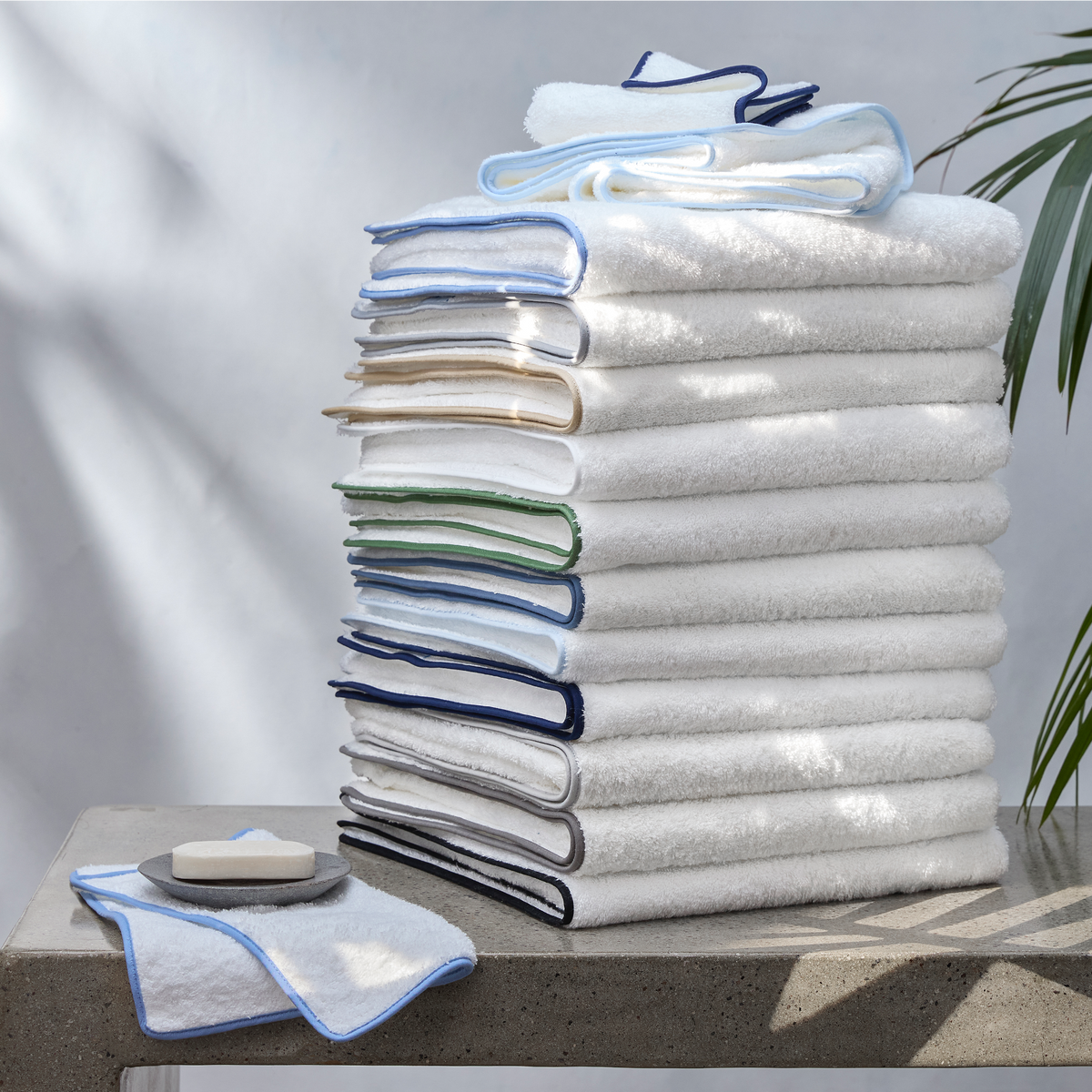 Stack of White Matouk Cairo Bath Towels with Different Colors of Accent Piping