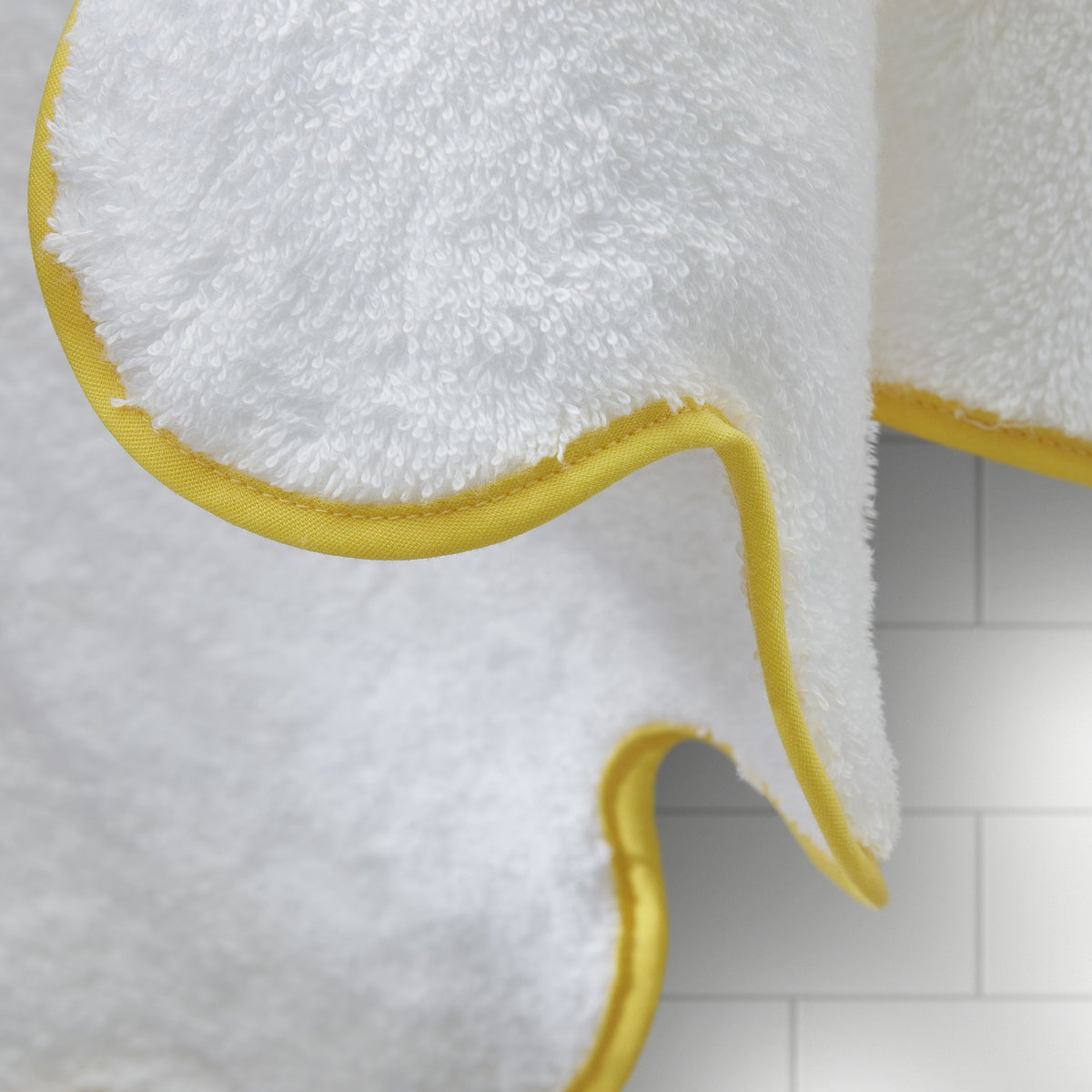 Close Up of Matouk Cairo Scallop Bath Towels and Mats in Lemon Color