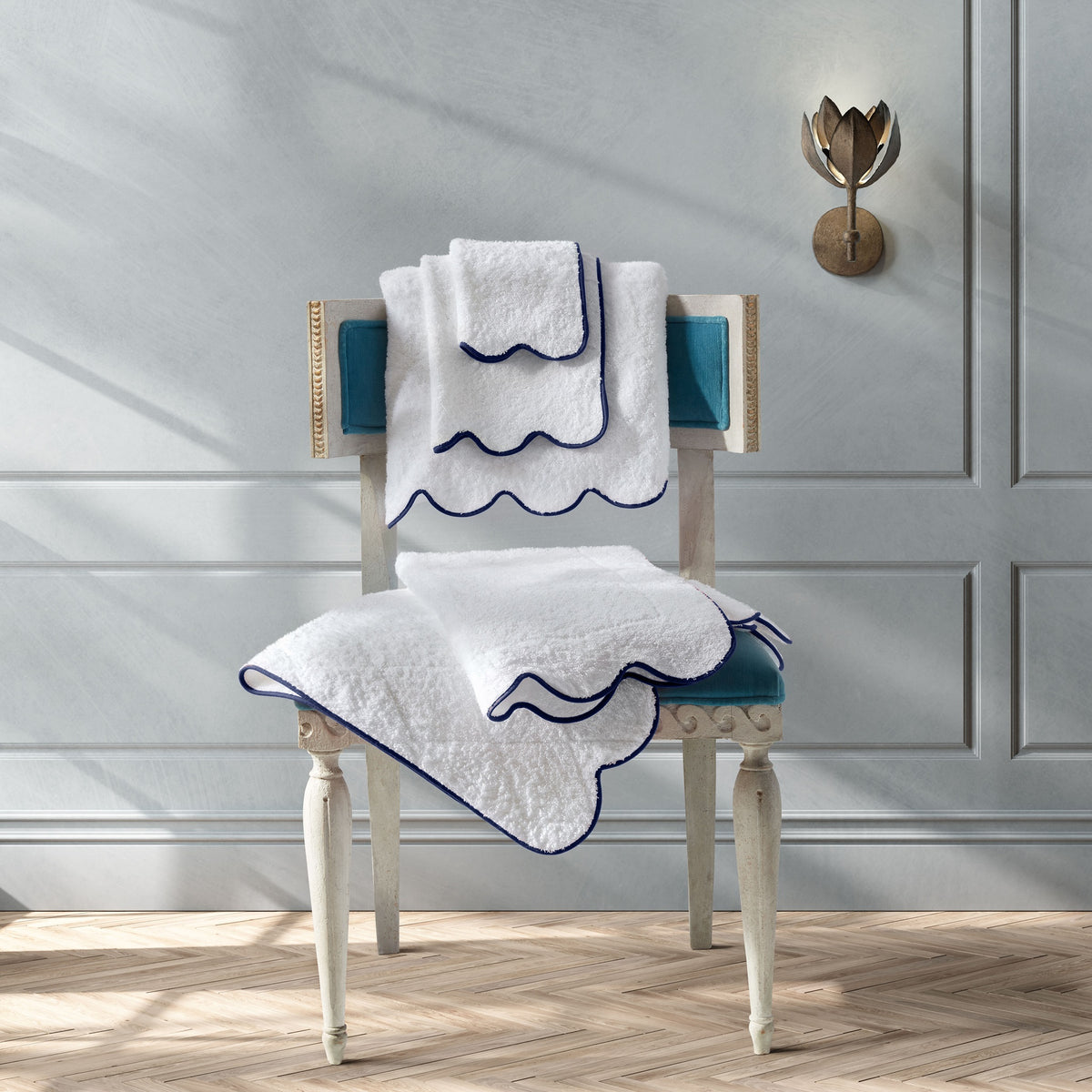 Matouk Cairo Scallop Bath Towels and Mats On A Chair