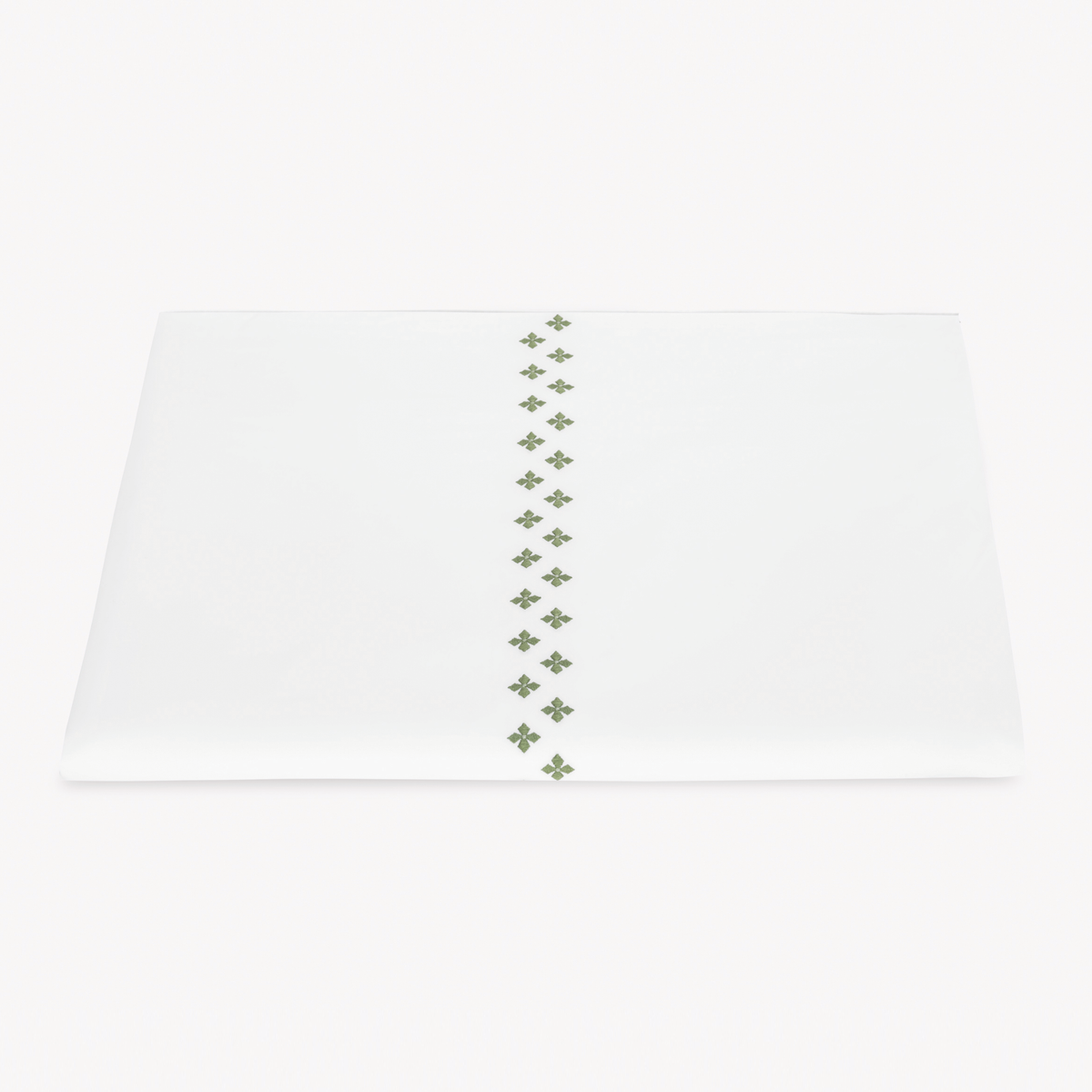 A folded white Egyptian cotton percale Duvet Cover featuring Matouk Casablanca Embroidery in Clover color