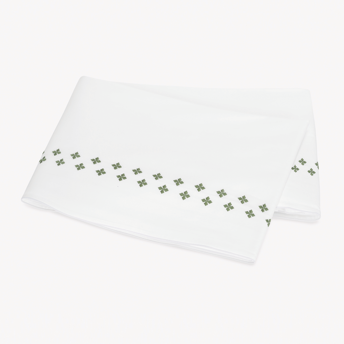 Folded white Flat Sheet in Egyptian cotton percale with Matouk Casablanca Embroidery in Clover color