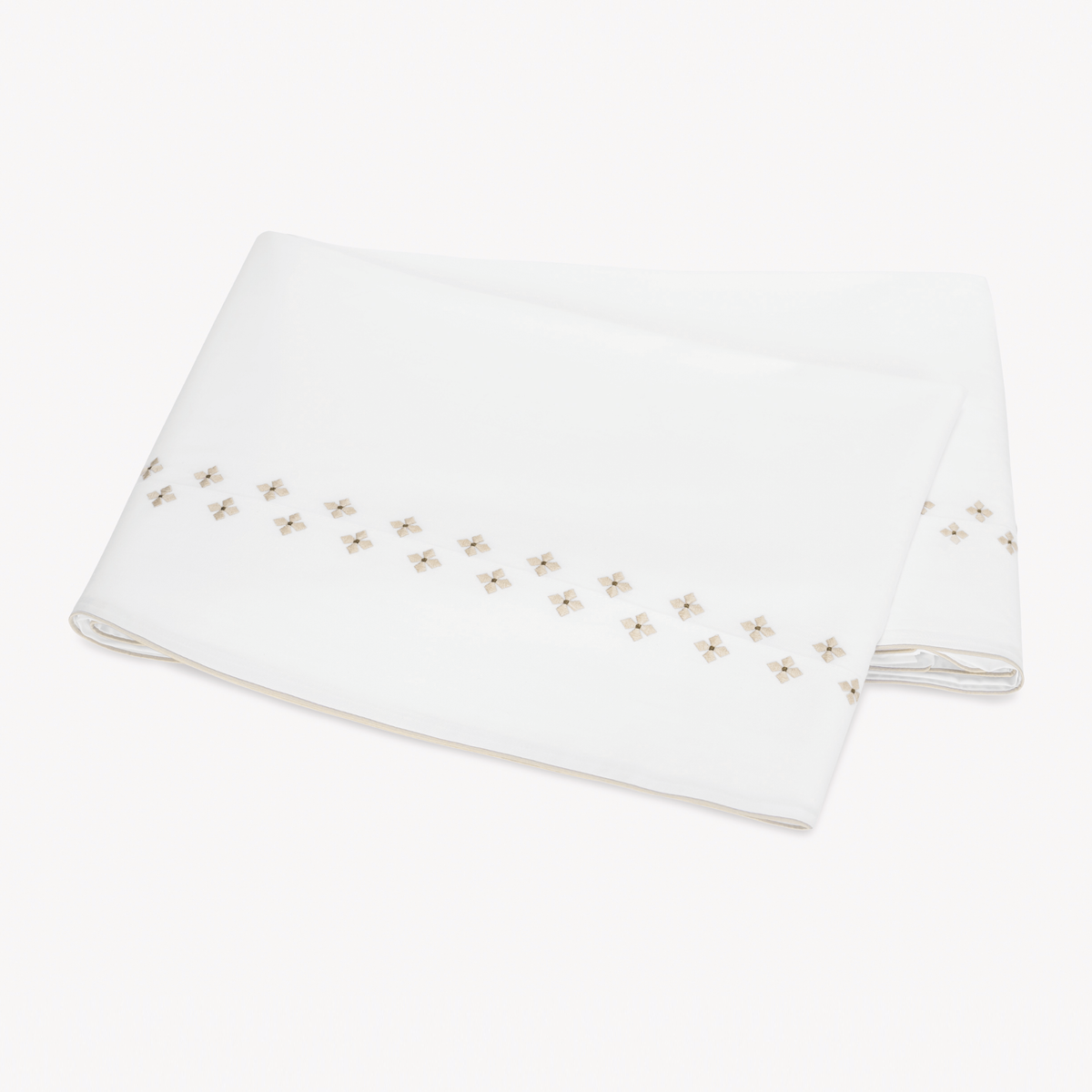 Folded white Flat Sheet in Egyptian cotton percale with Matouk Casablanca Embroidery in Dune color