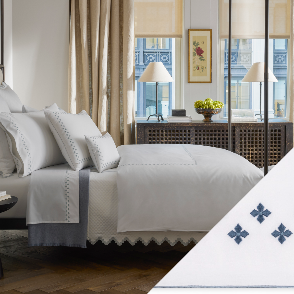 A neatly made bed with Matouk Casablanca bedding features Indigo color Embroidered Swatch