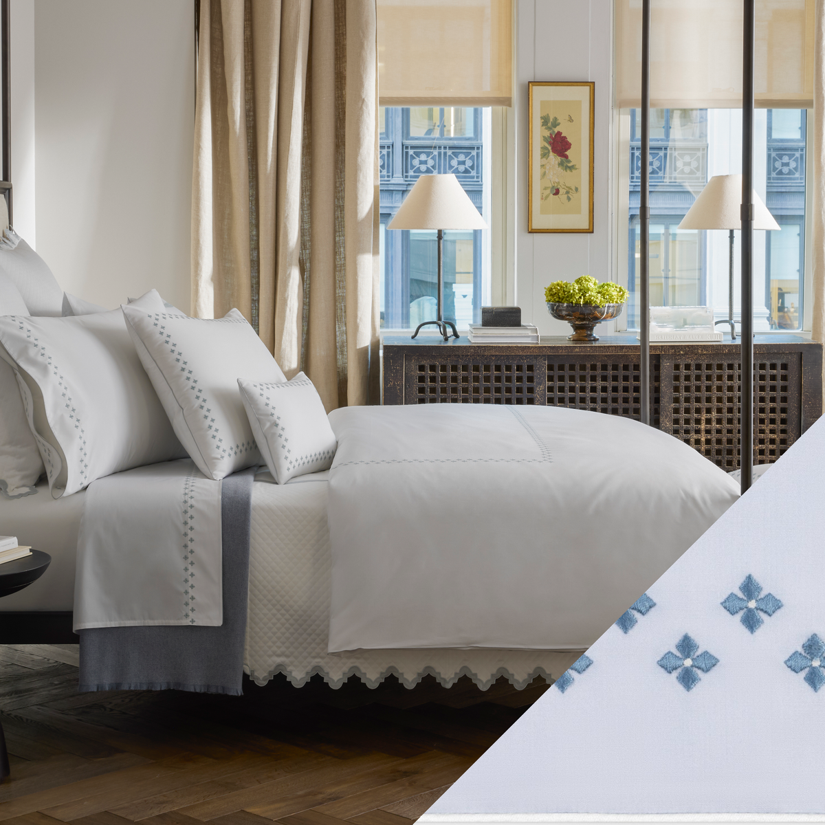 A neatly made bed with Matouk Casablanca bedding features Sky Blue color Embroidered Swatch