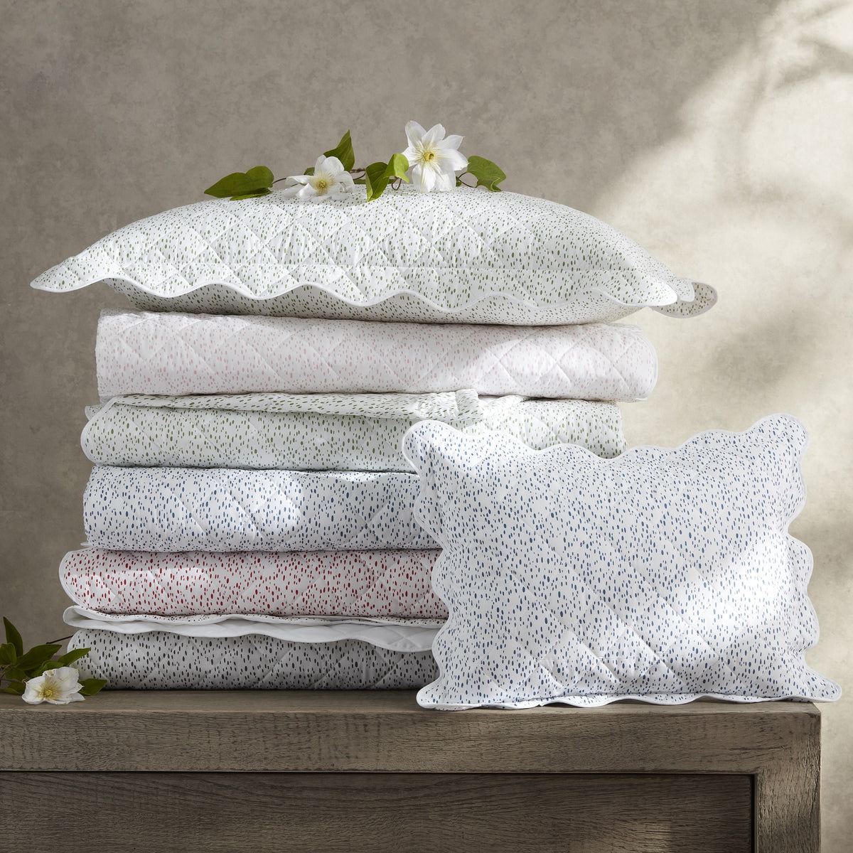 Stack of Matouk Celine Quilted Bedding in Different Colors