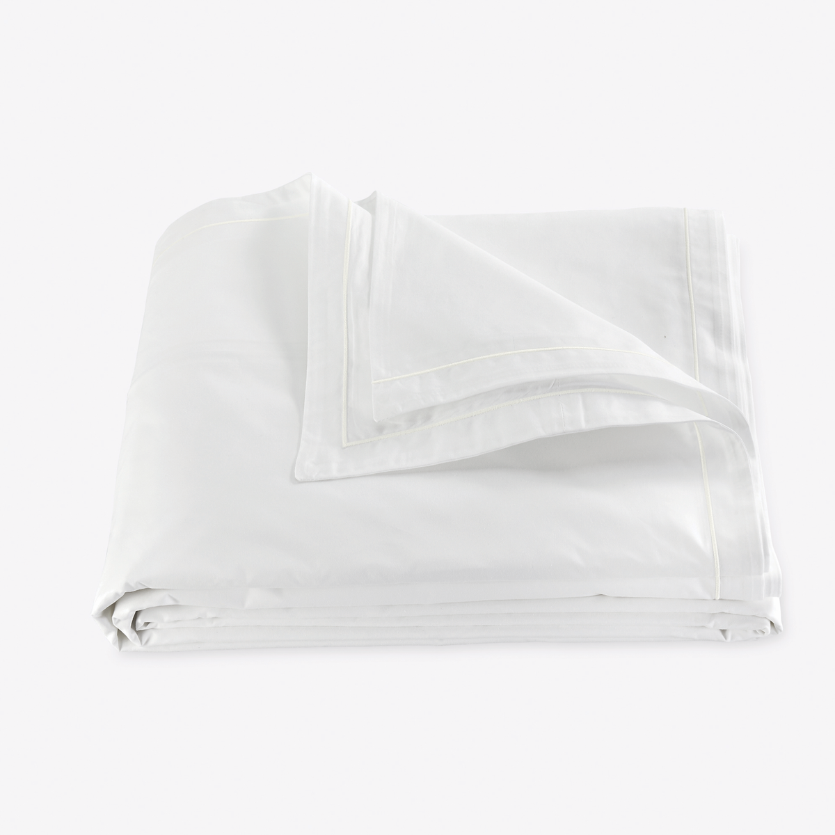 Folded Duvet Cover of Bone Color Matouk Ceylon Satin Stitch Bedding