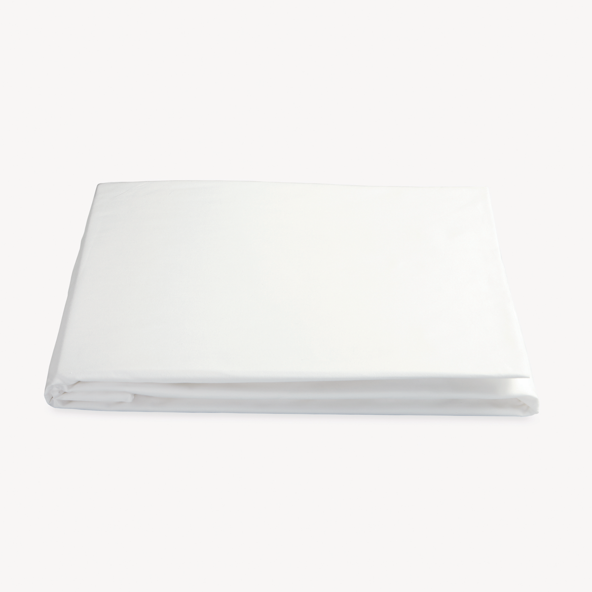 Folded Fitted Sheet of Bone Color Matouk Ceylon Satin Stitch Bedding