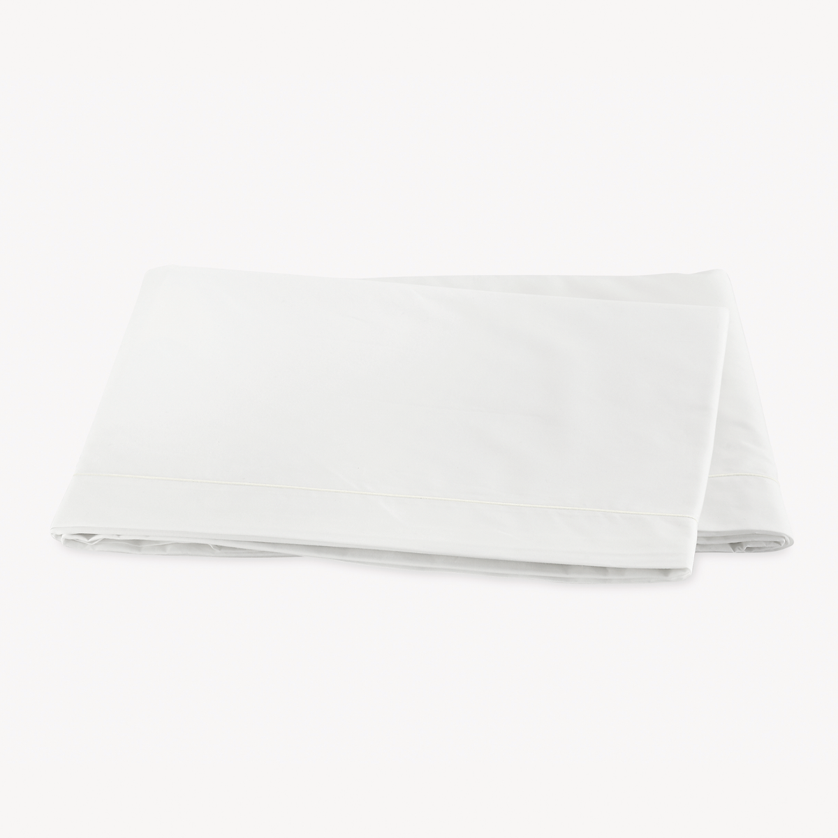 Folded Flat Sheet of Bone Color Matouk Ceylon Satin Stitch Bedding