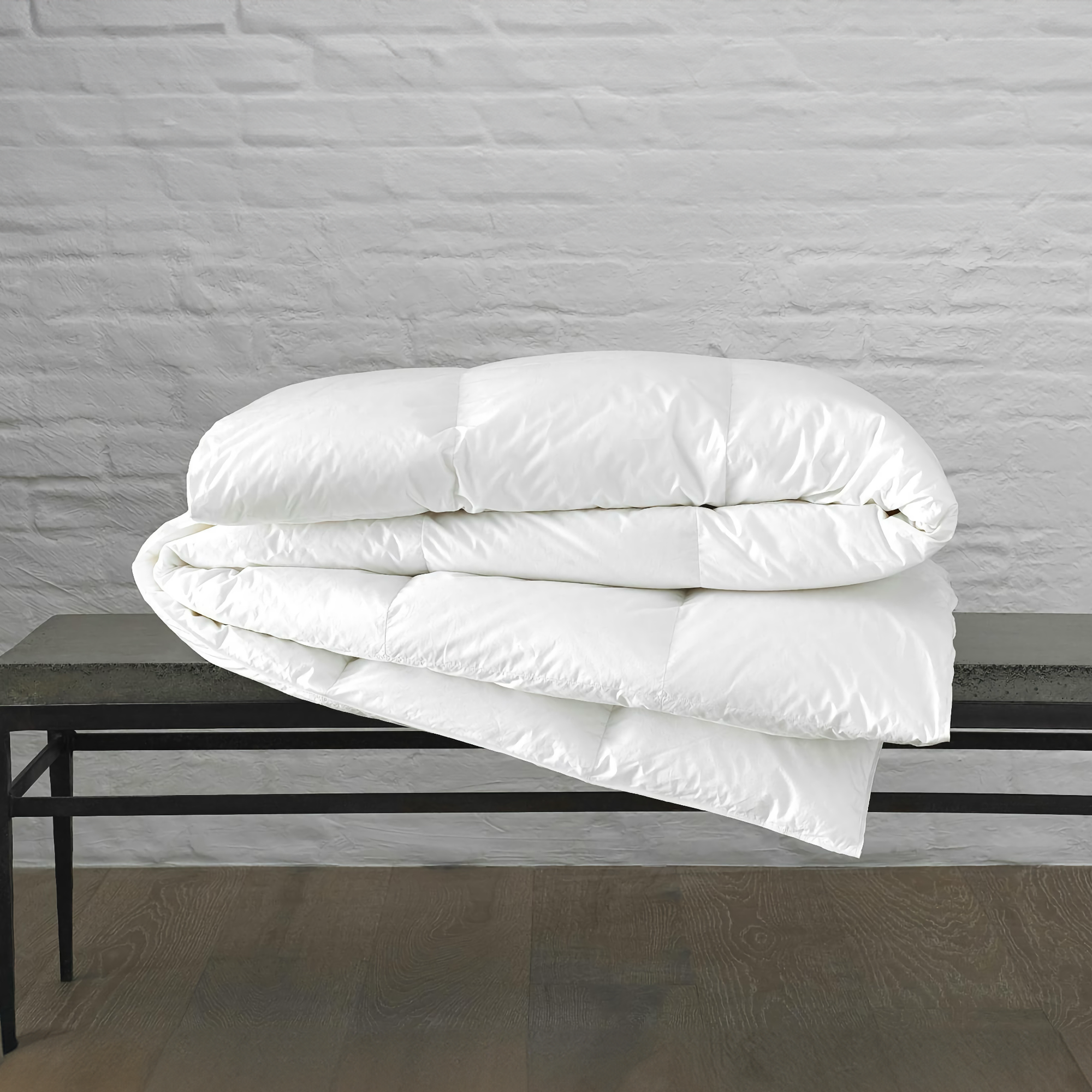 Folded Matouk Chalet Comforter on a Bench