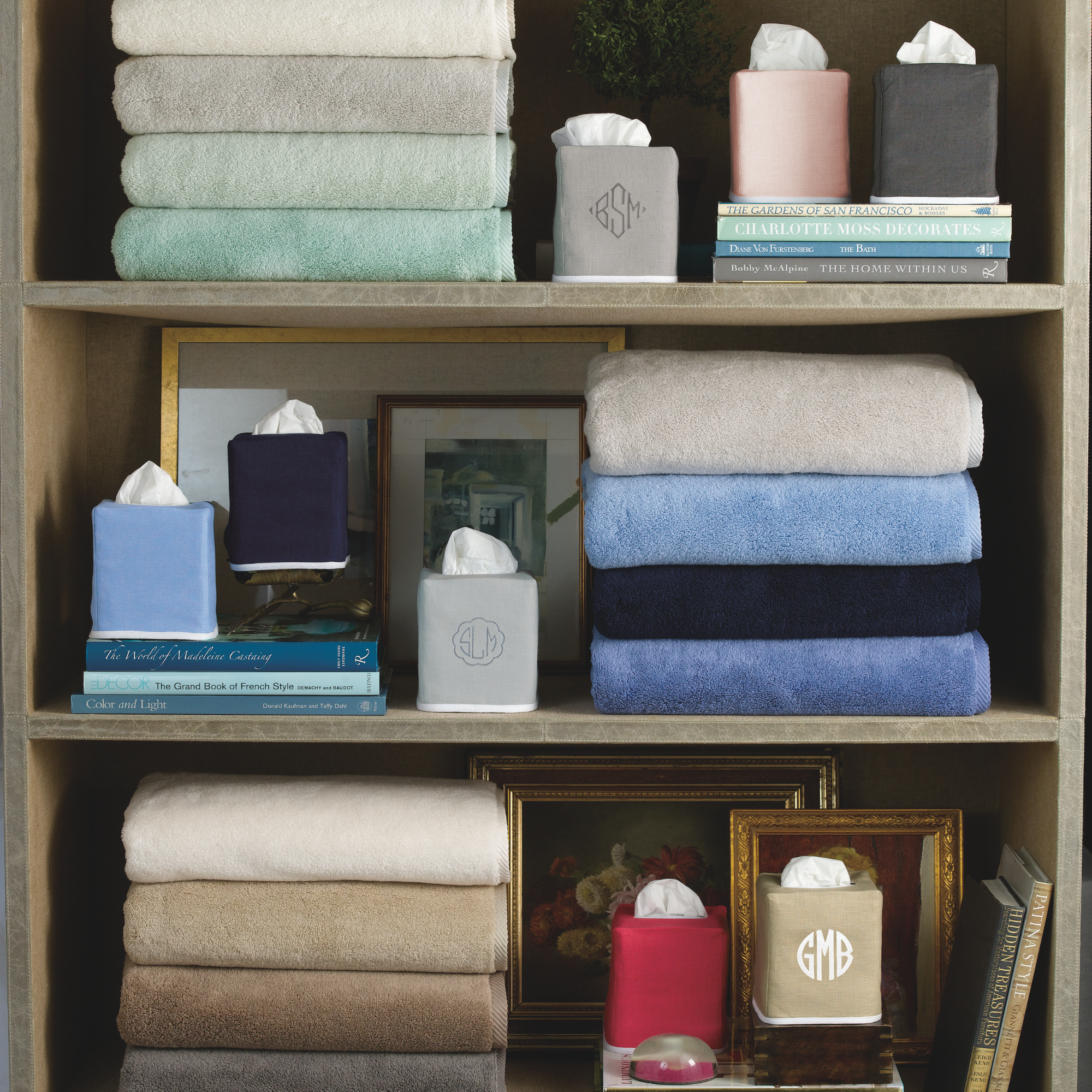 Lifestyle Shot of Matouk Chelsea Linen Tissue Box Covers on a Cabinet with Towels