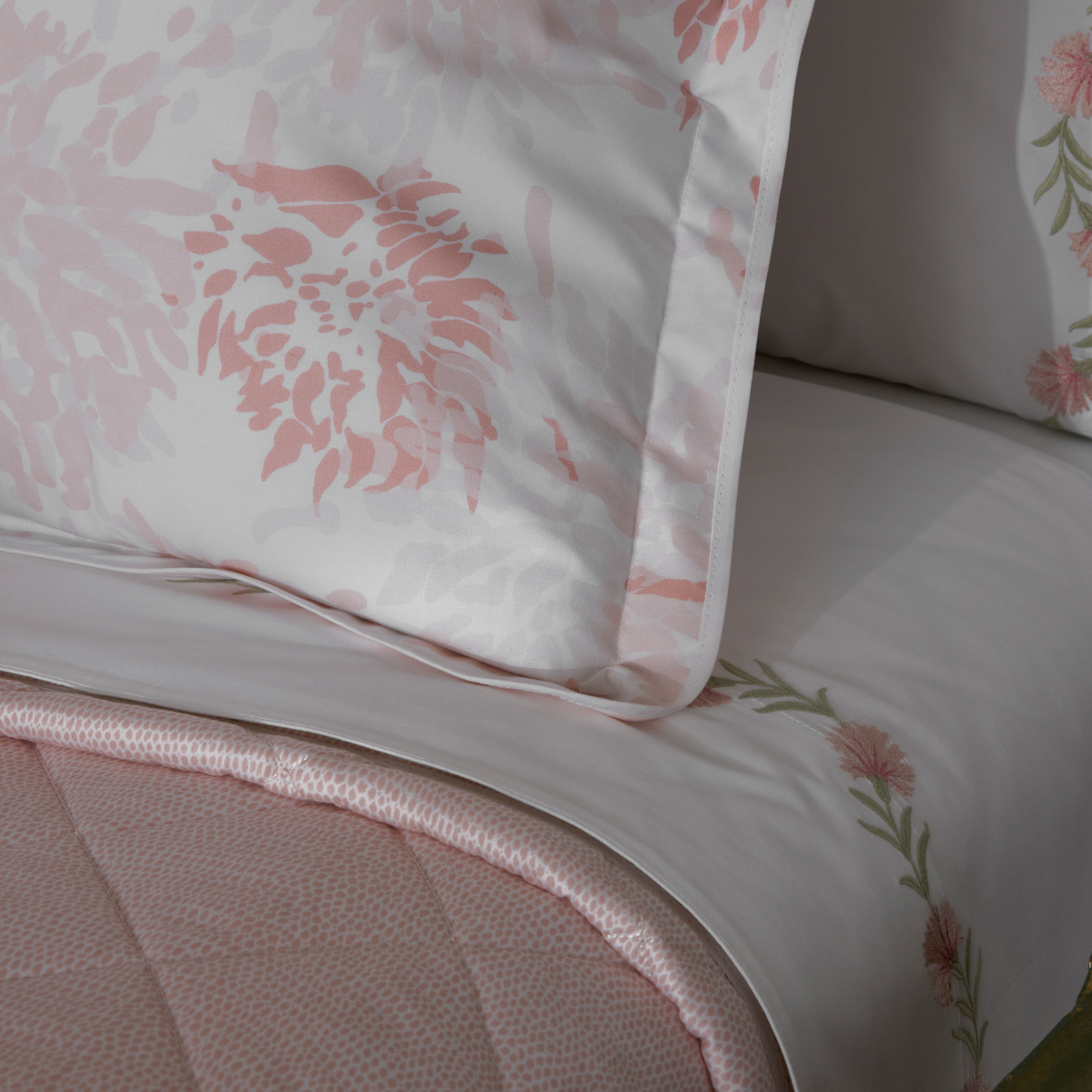 Close-up of Blush Matouk Chrysanthemum bedding with Daphne in Peony