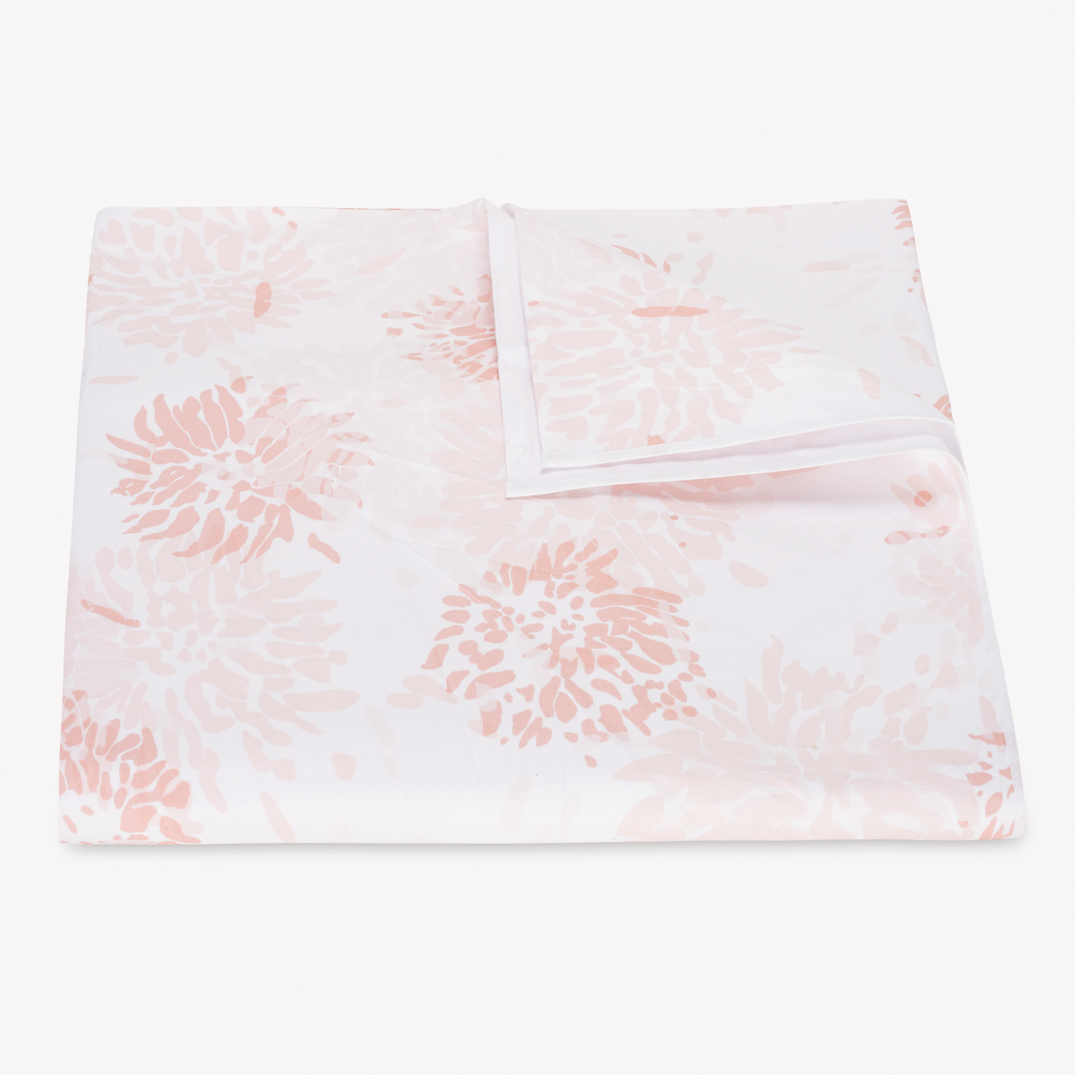Folded Duvet Cover with blush floral-patterned Matouk Chrysanthemum bedding, with one corner lifted to show the underside