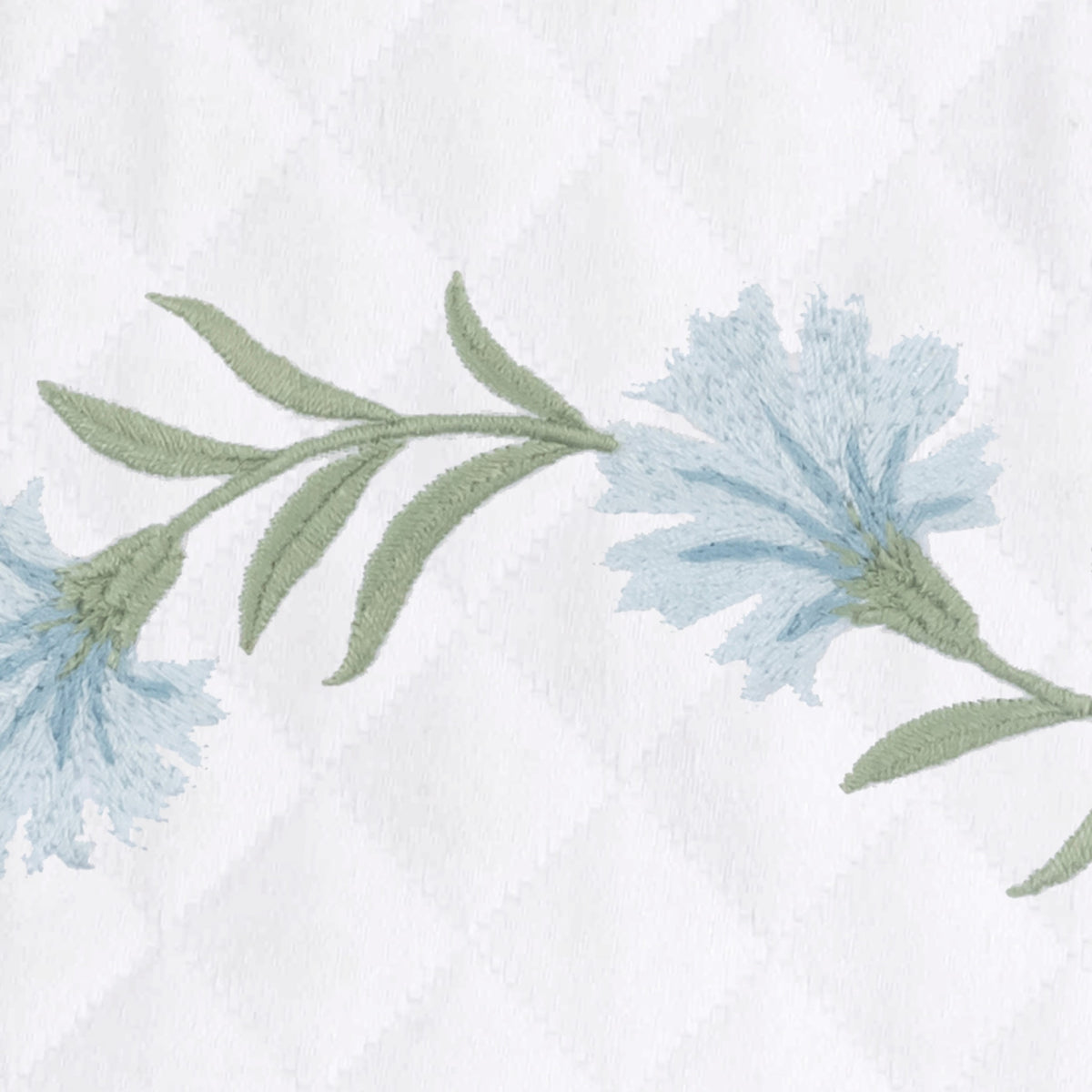 Bluebell embroidered florals with leaves on white OEKO-TEX certified cotton matelassé, featuring a Matouk Matelasse fabric