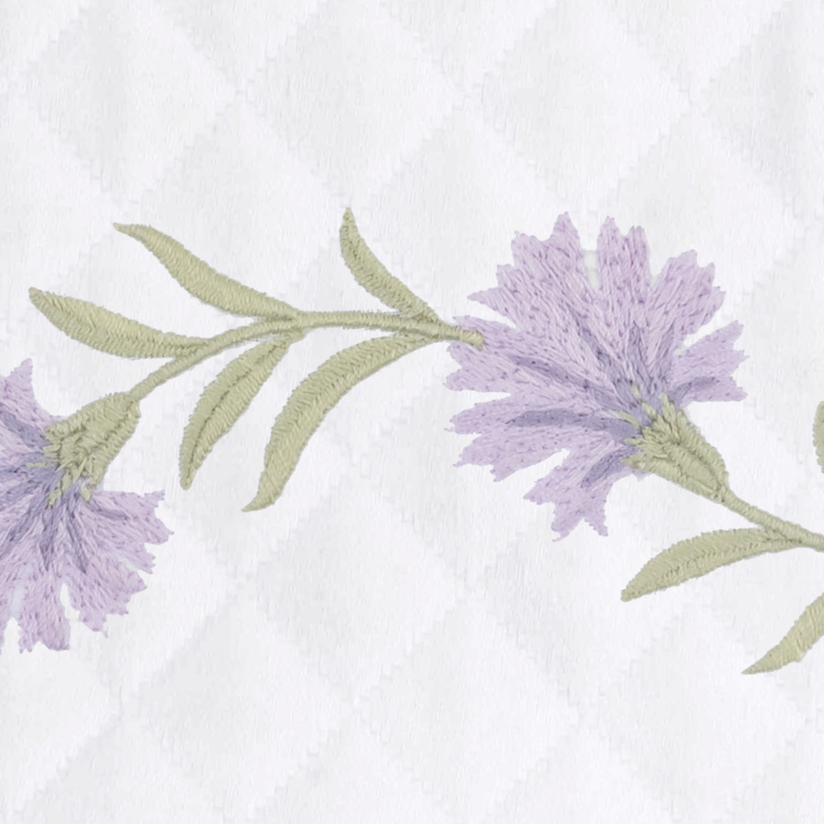 Lilac embroidered florals with leaves on white OEKO-TEX certified cotton matelassé, featuring a Matouk Matelasse fabric