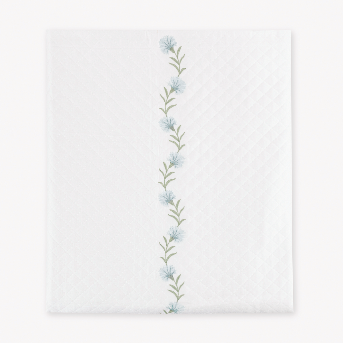 Folded Coverlet of Matouk Daphne Matelasse Bedding with Bluebell design