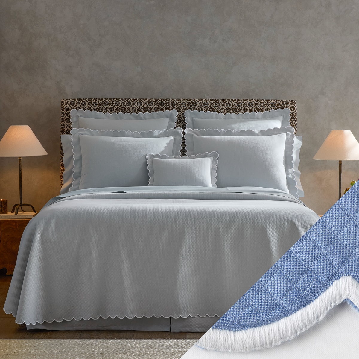  neatly made bed with Matouk Diamond Pique Bedding, two lamps on nightstands, and a close-up of Azure swatch